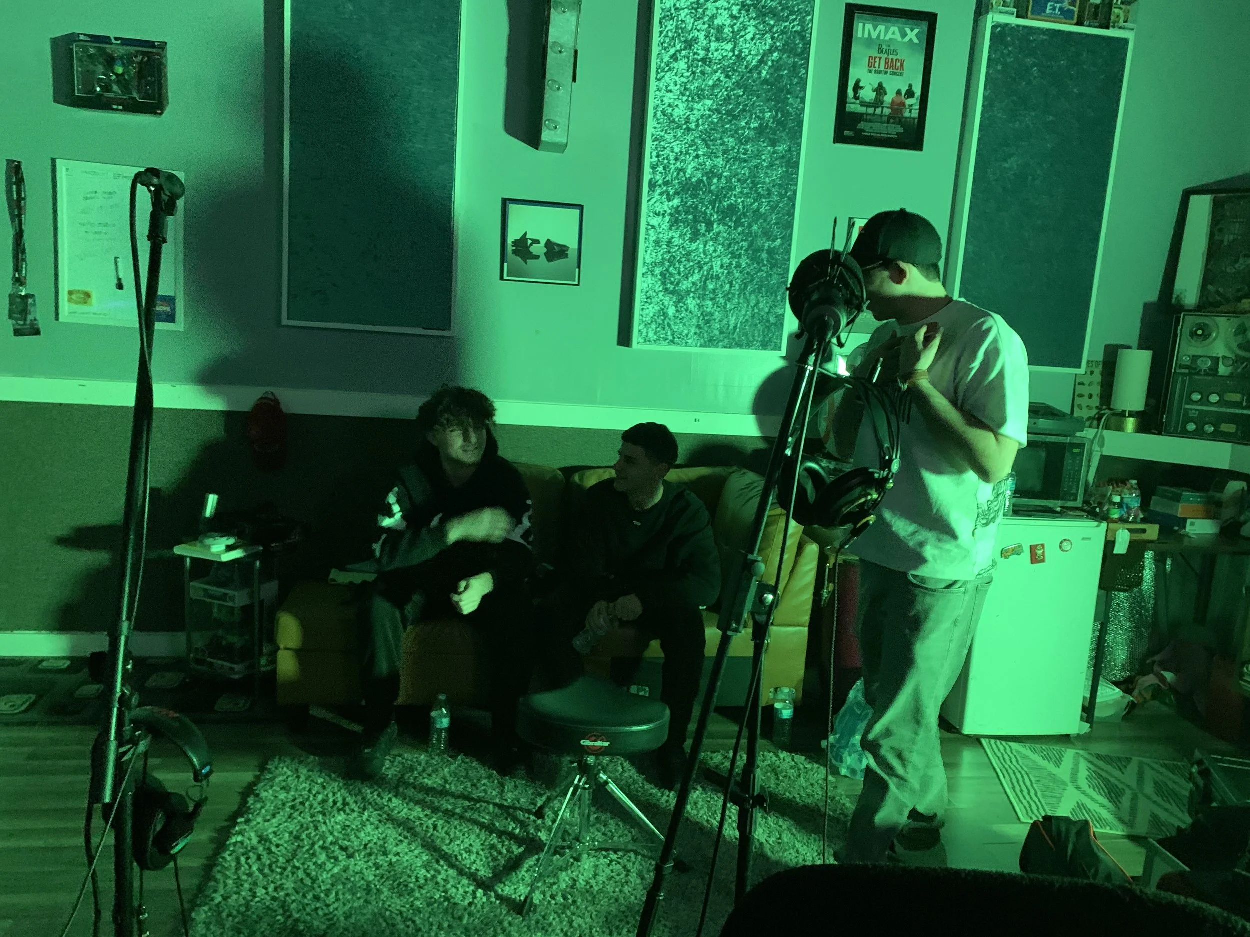 Scenic view of mountains with a lake in the foreground, grassy hills, and a cloudy sky.
