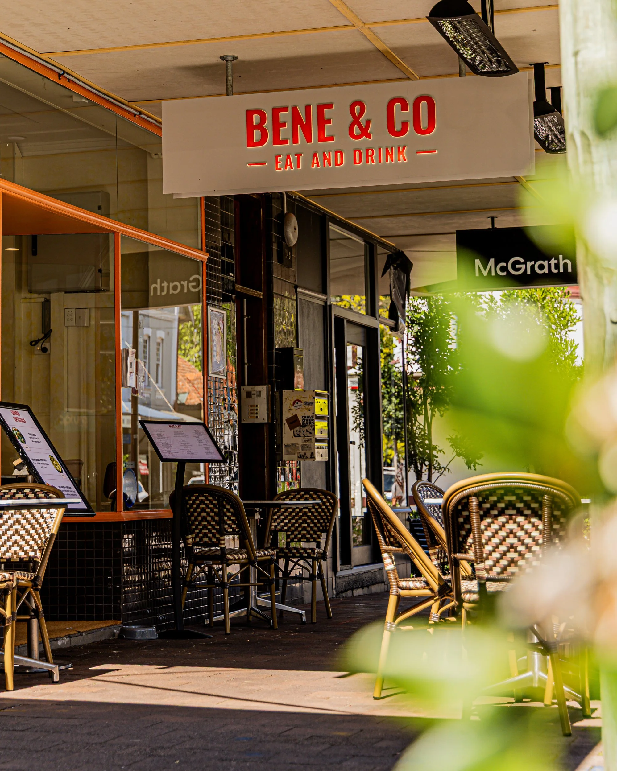 Exterior of Bene & Co Italian restaurant in McMahons Point showing the outdoor alfresco dining area and signage on Blues Point Road, North Sydney.