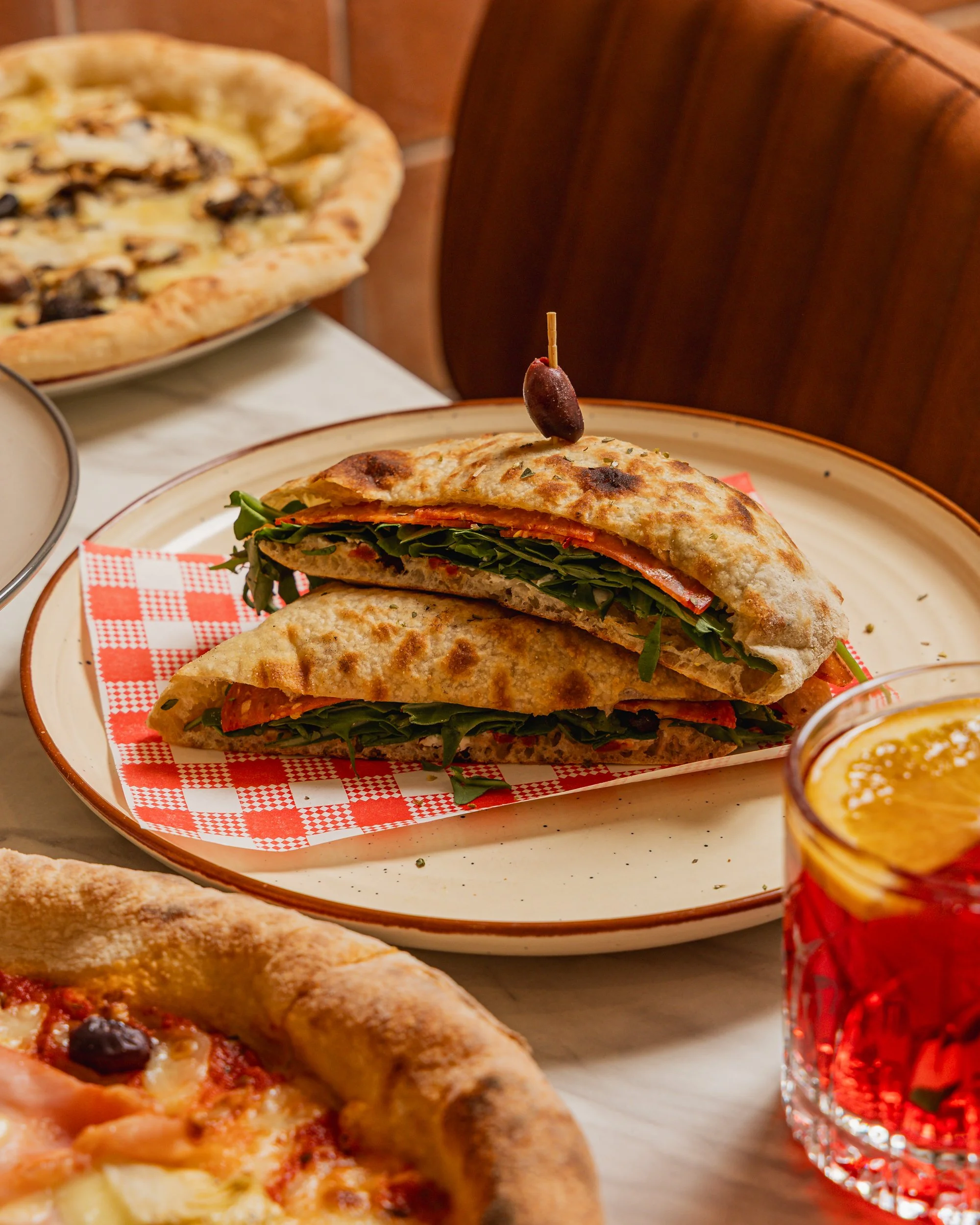 Authentic Italian deli lunch in North Sydney featuring a 72-hour fermented focaccia sandwich and traditional wood-fired pizza at Bene & Co McMahons Point.