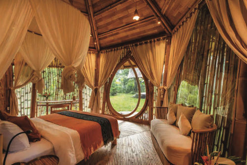 meanwhil, Bamboo eco-lodge accommodation featuring a cozy bedroom with natural materials and garden views.
