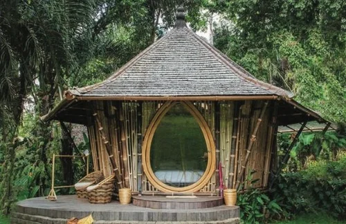 Sustainable bamboo pavilion surrounded by lush greenery at Kul Kul Farm Bali showcasing eco-friendly architecture.