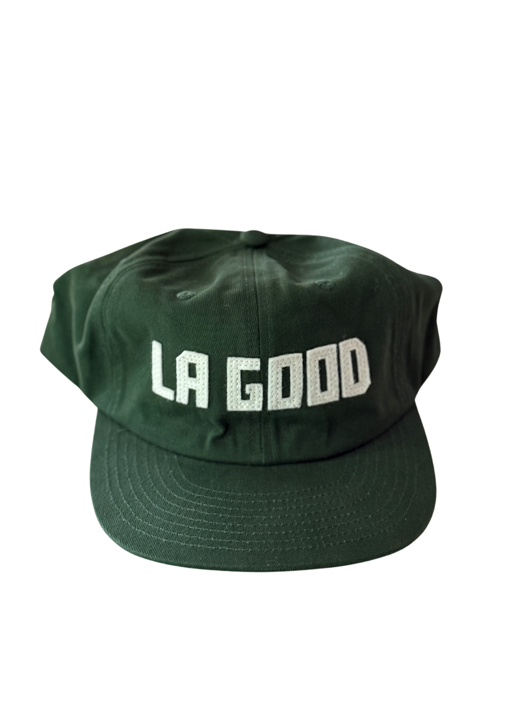 Green baseball cap with white embroidered text that reads 'LA GOO'.