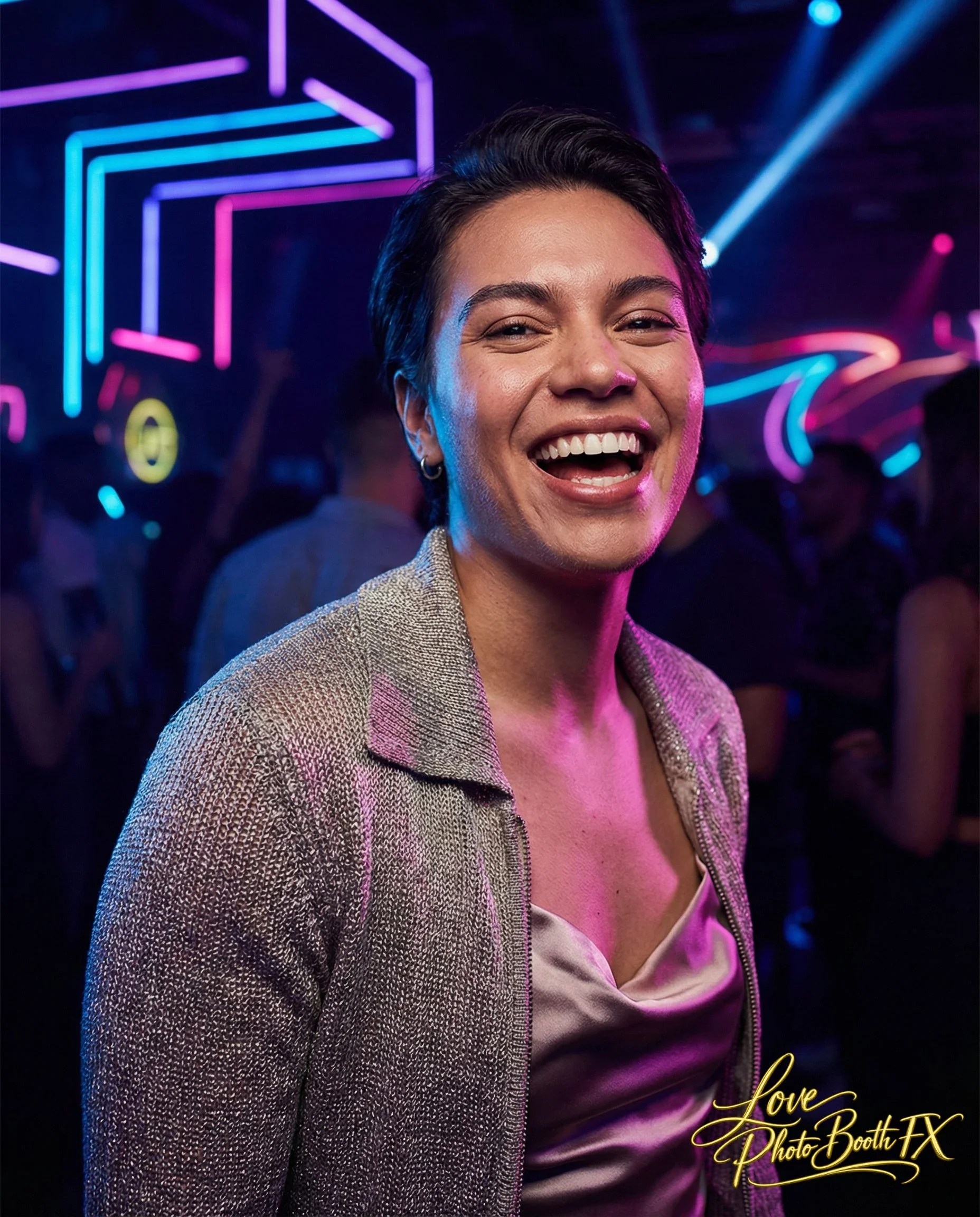A woman smiling at a party or nightclub with colorful neon lights in the background.
