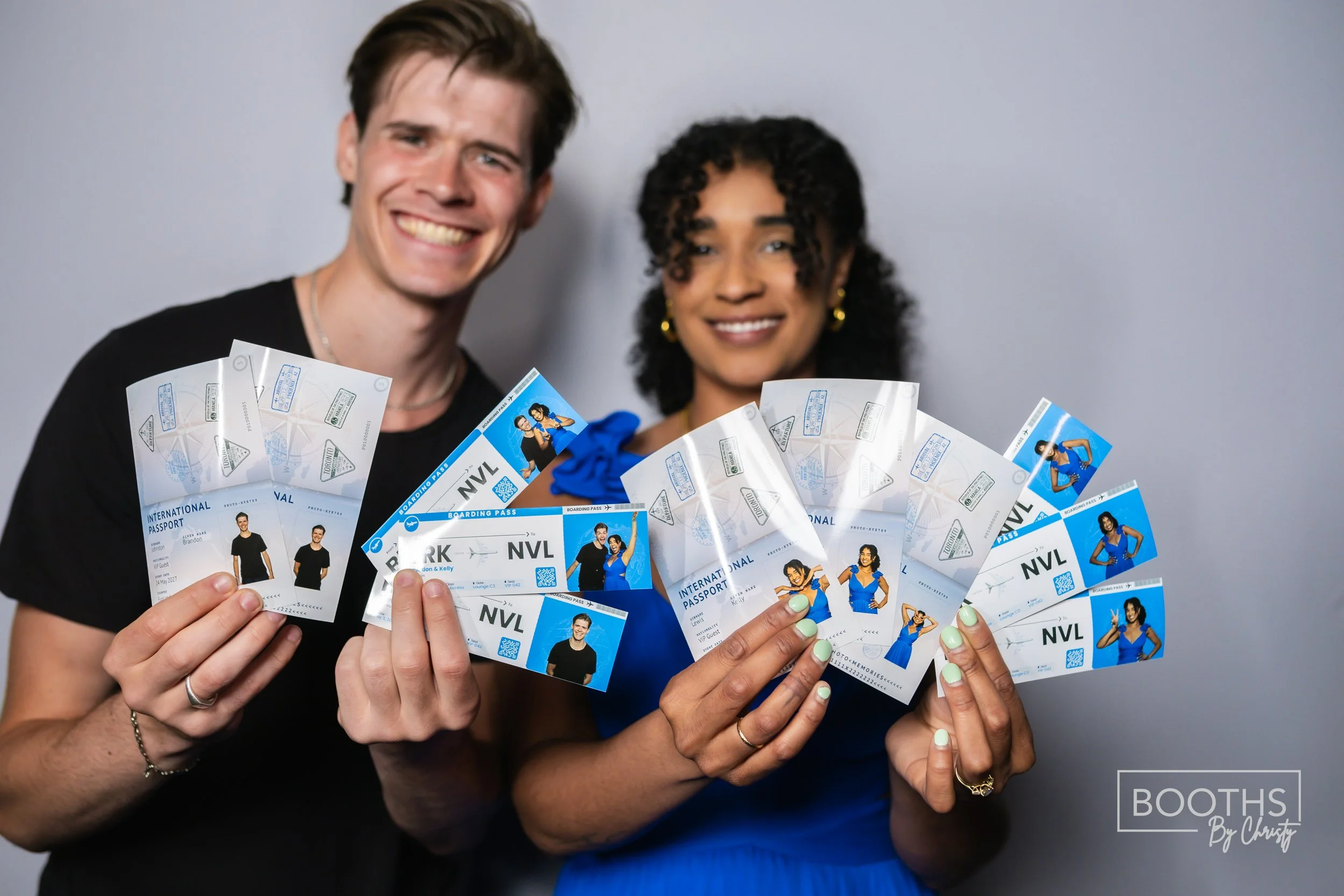 A man and woman smiling and holding multiple boarding passes for international travel.