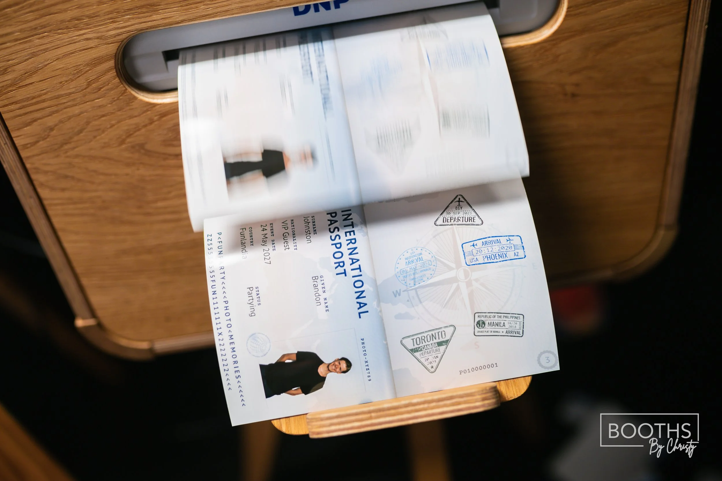 Open international airplane passport showing stamps, a photo of a woman, and a boarding pass on a wooden table.