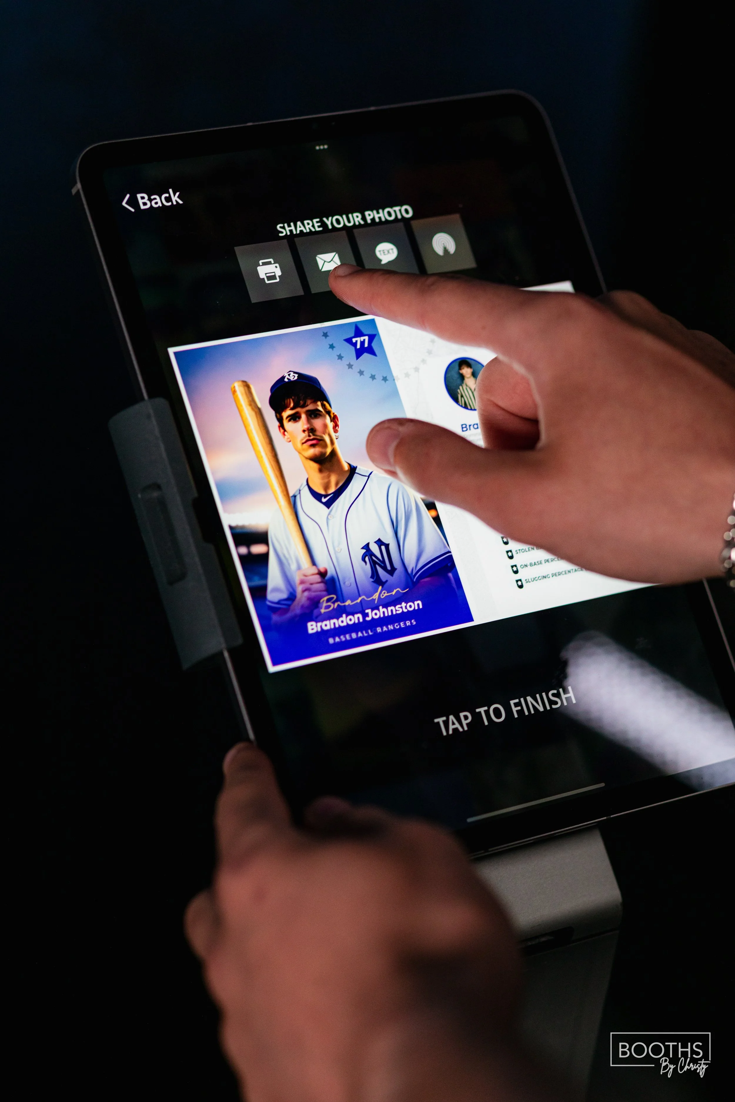 Close-up of a person using a smartphone to share a baseball card image of Brandon Johnston, a baseball player, via email or message app; the screen shows options for sharing and a baseball card with a young man in a baseball uniform holding a bat.