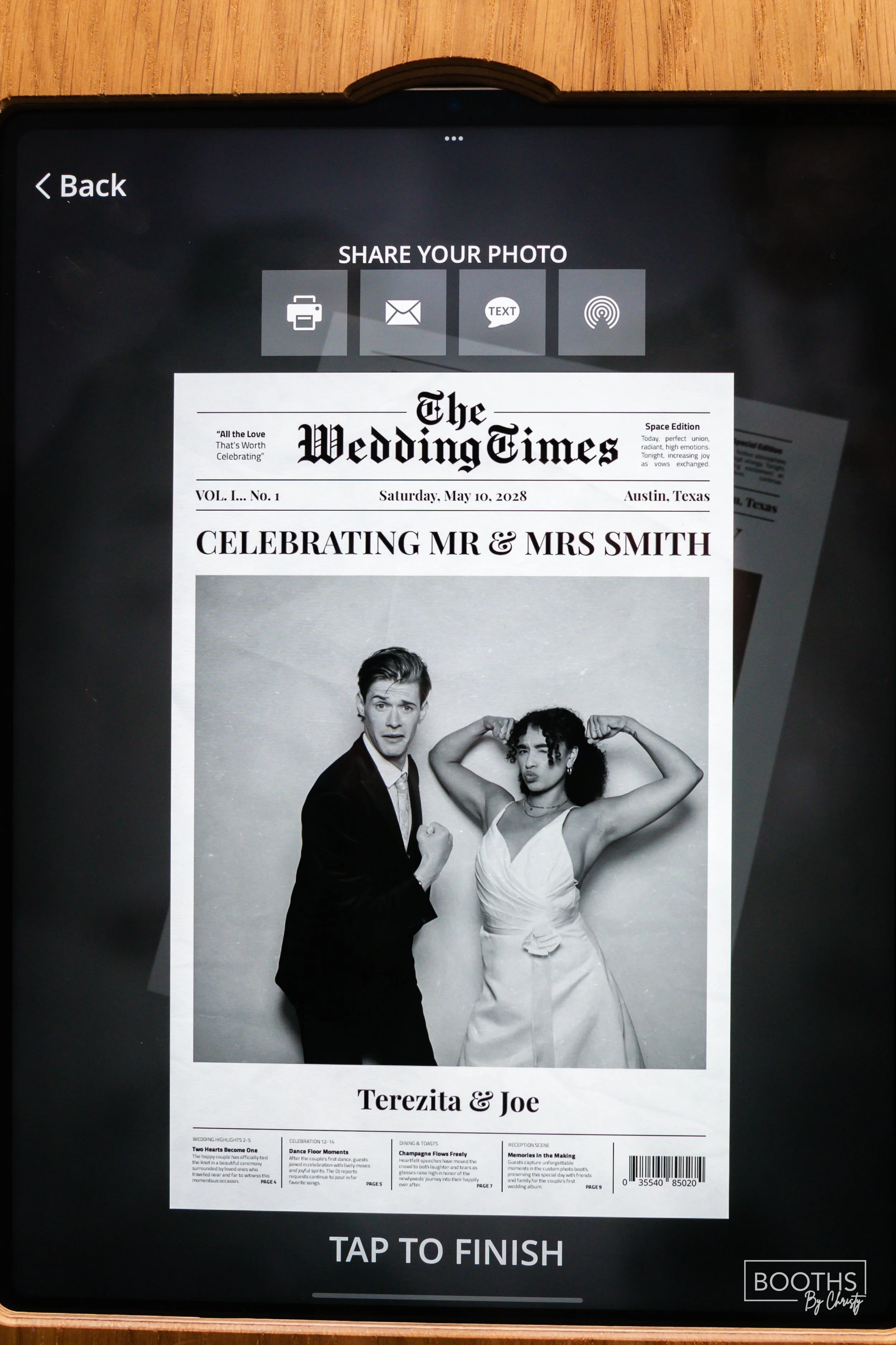 A digital display showing a black-and-white newspaper-style wedding announcement for Terezita and Joe, with a photo of a man in a suit and a woman in a dress flexing their muscles.