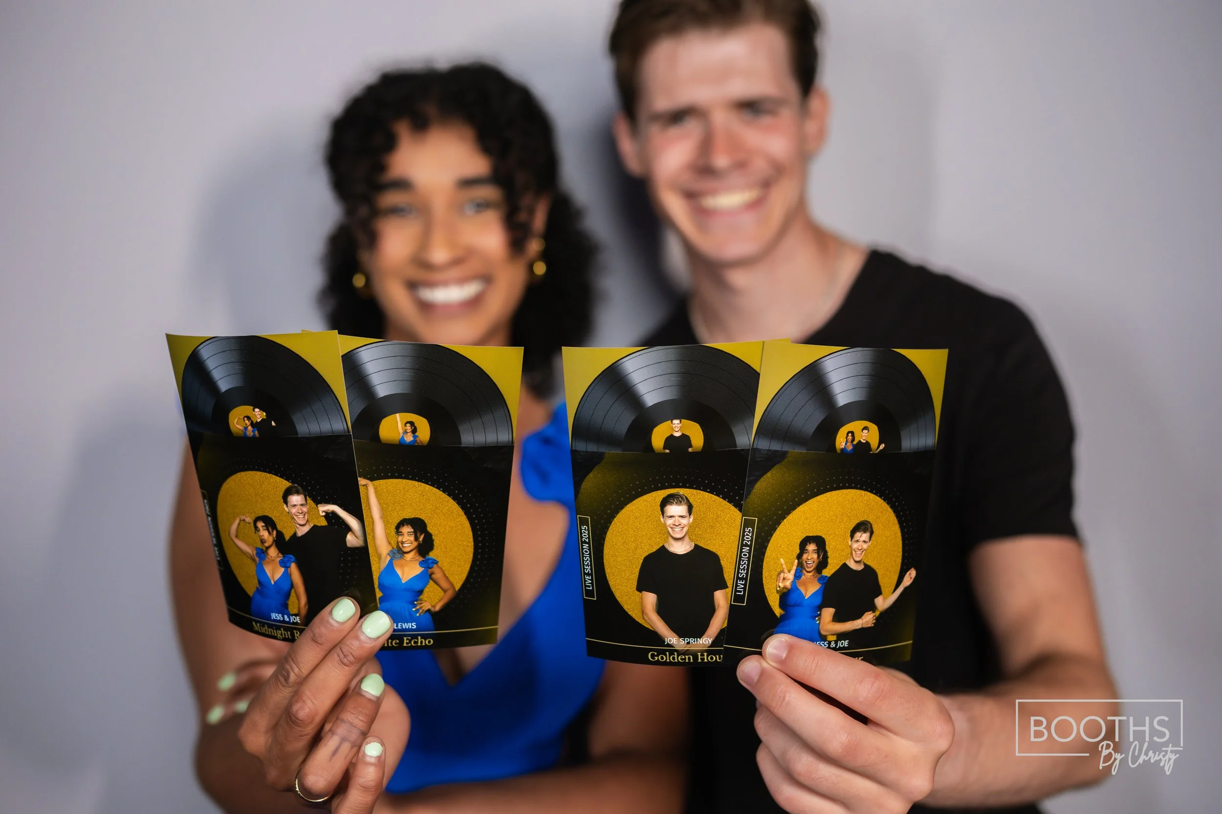 Two smiling people holding photobooth pictures featuring individuals posing with a yellow and black background, with music record graphics at the top.