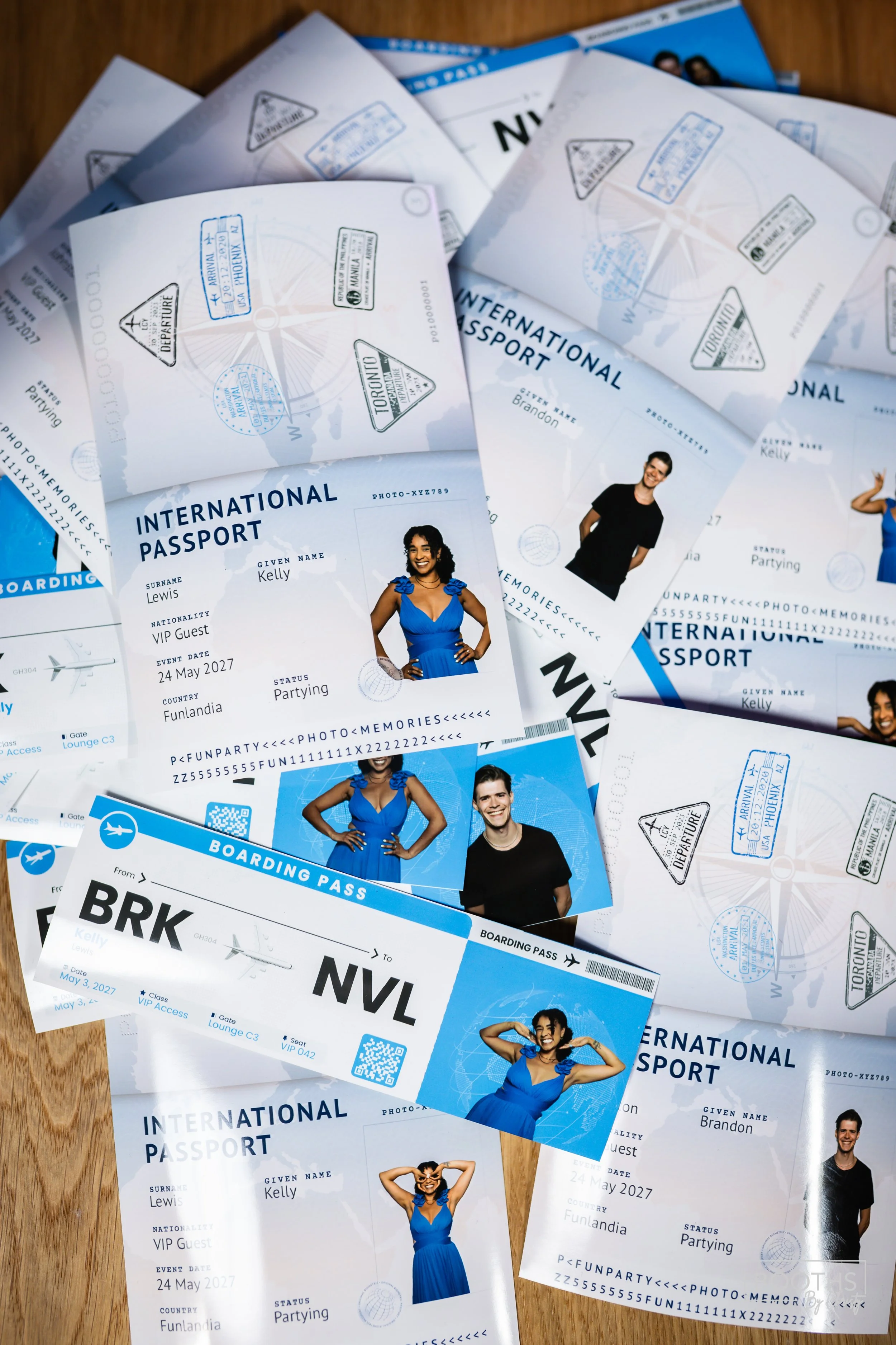 Several international passports, boarding passes, and photos of smiling young people in blue dresses and black shirts scattered on a wooden surface.