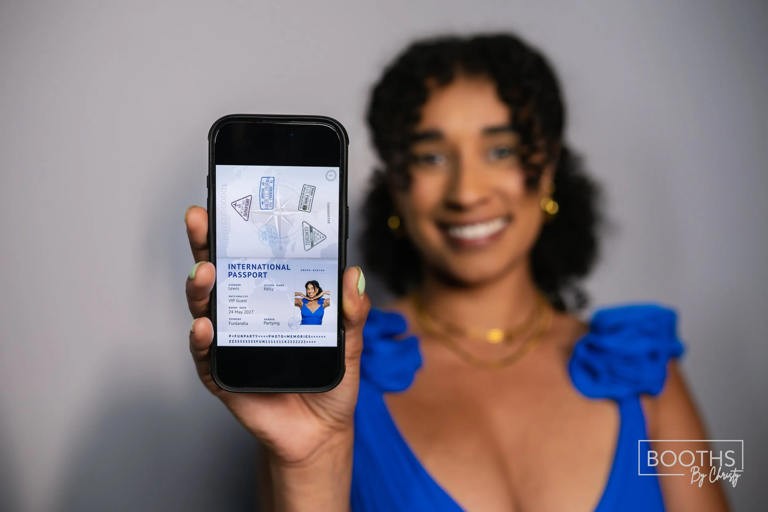 Woman holding a smartphone showing an international passport with a smiling face and blue dress, with travel stamps in the background.