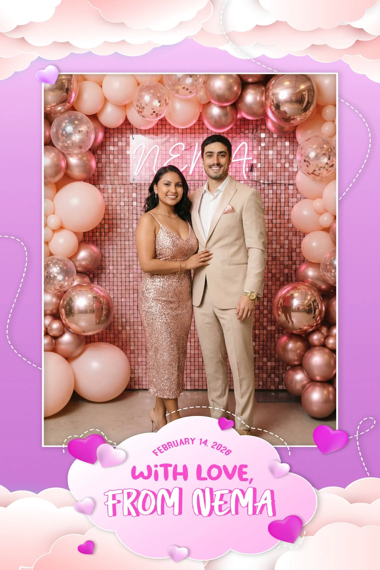 A man and woman dressed in elegant attire posing in front of a pink pixelated backdrop with balloons, with the woman in a sequined dress and the man in a beige suit, celebrating Valentine’s Day on February 14, 2026, with a sign that says 'Nema' behin