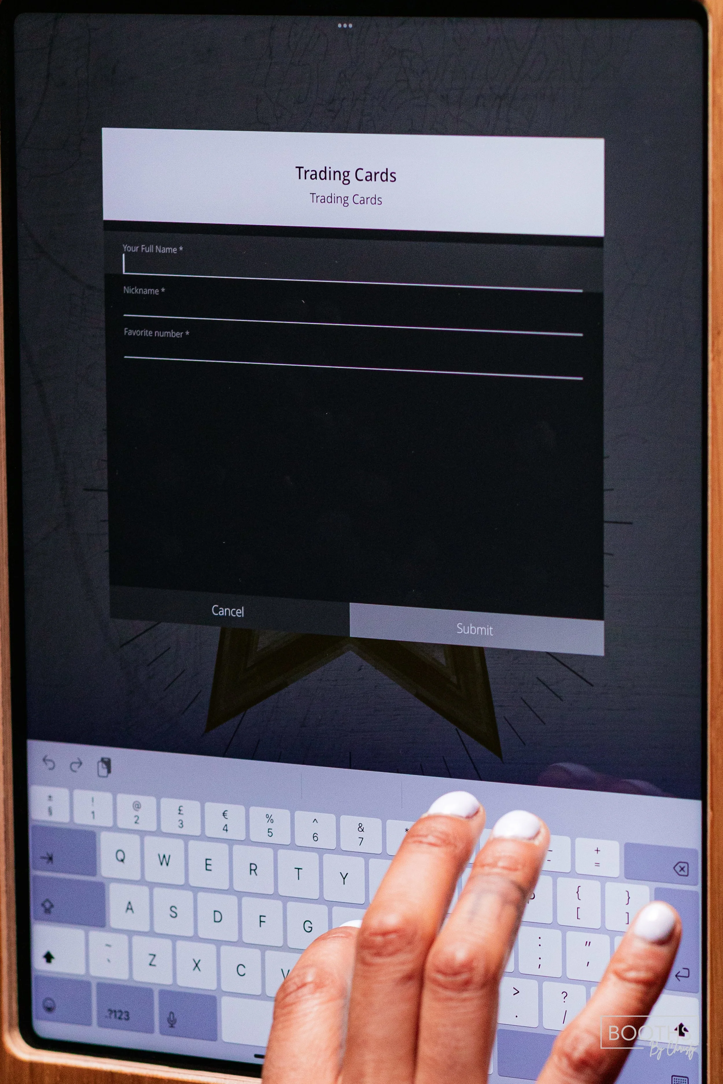 A digital tablet screen displaying a form titled 'Trading Cards' with fields for full name, nickname, and favorite number being filled out with a person's hand.