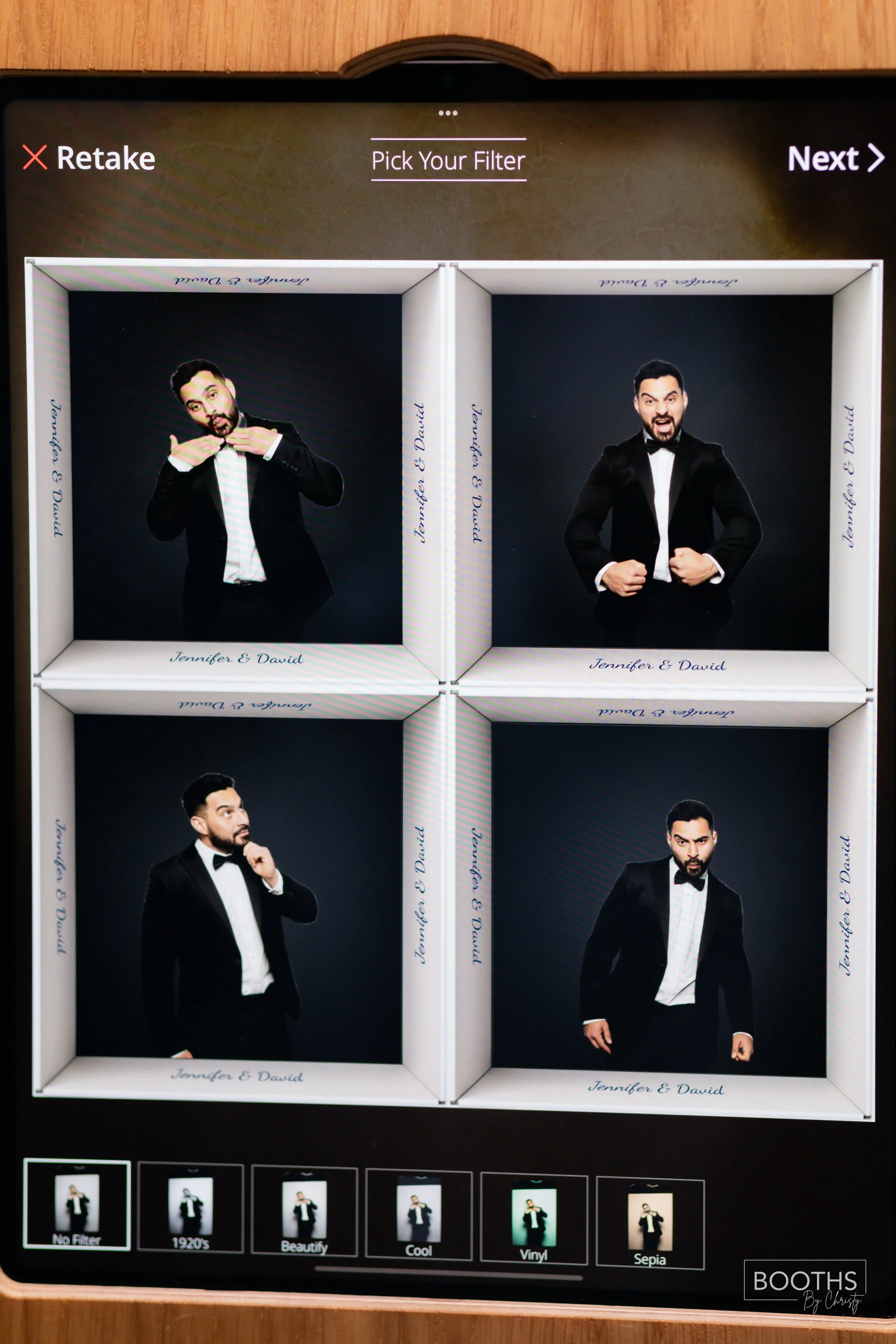 Four men dressed in tuxedos taking fun portrait photographs inside a photo booth with personalized frames labeled 'Jennifer & David'.