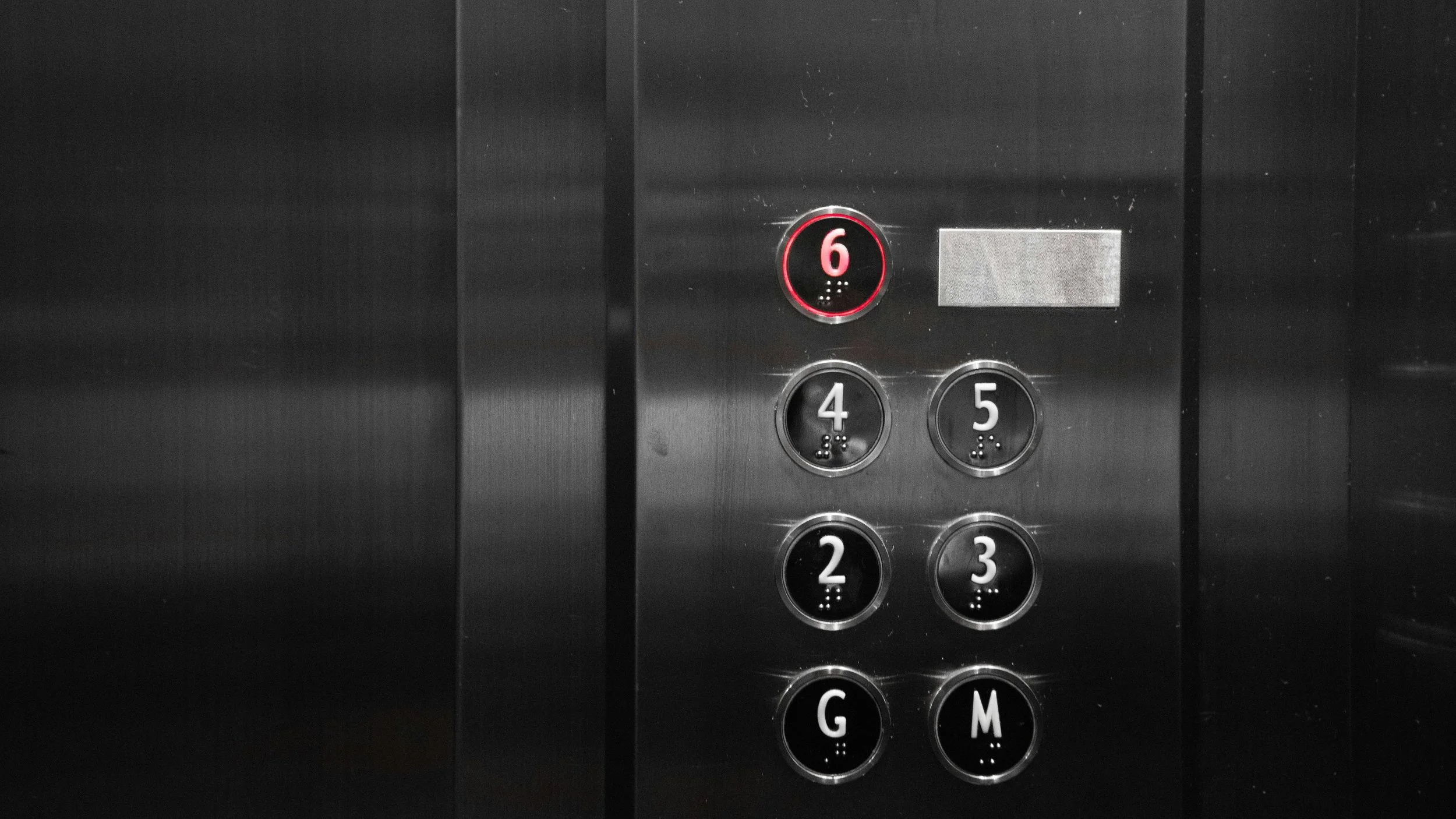 Close up of metal elevator buttons