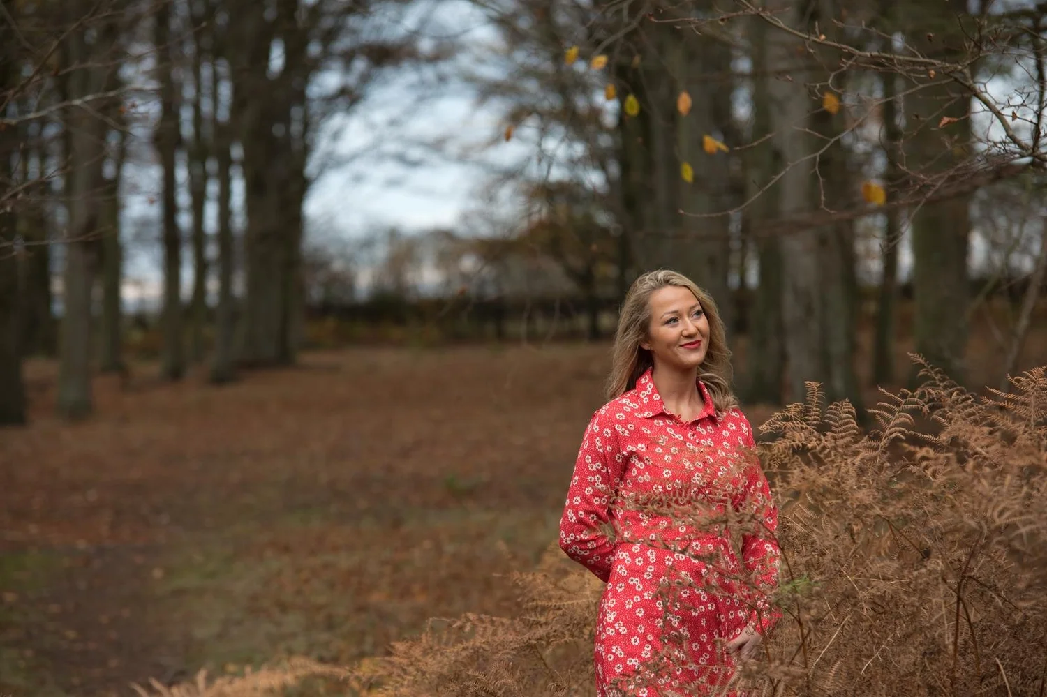 Rochelle Oliver outdoors in a red floral dress