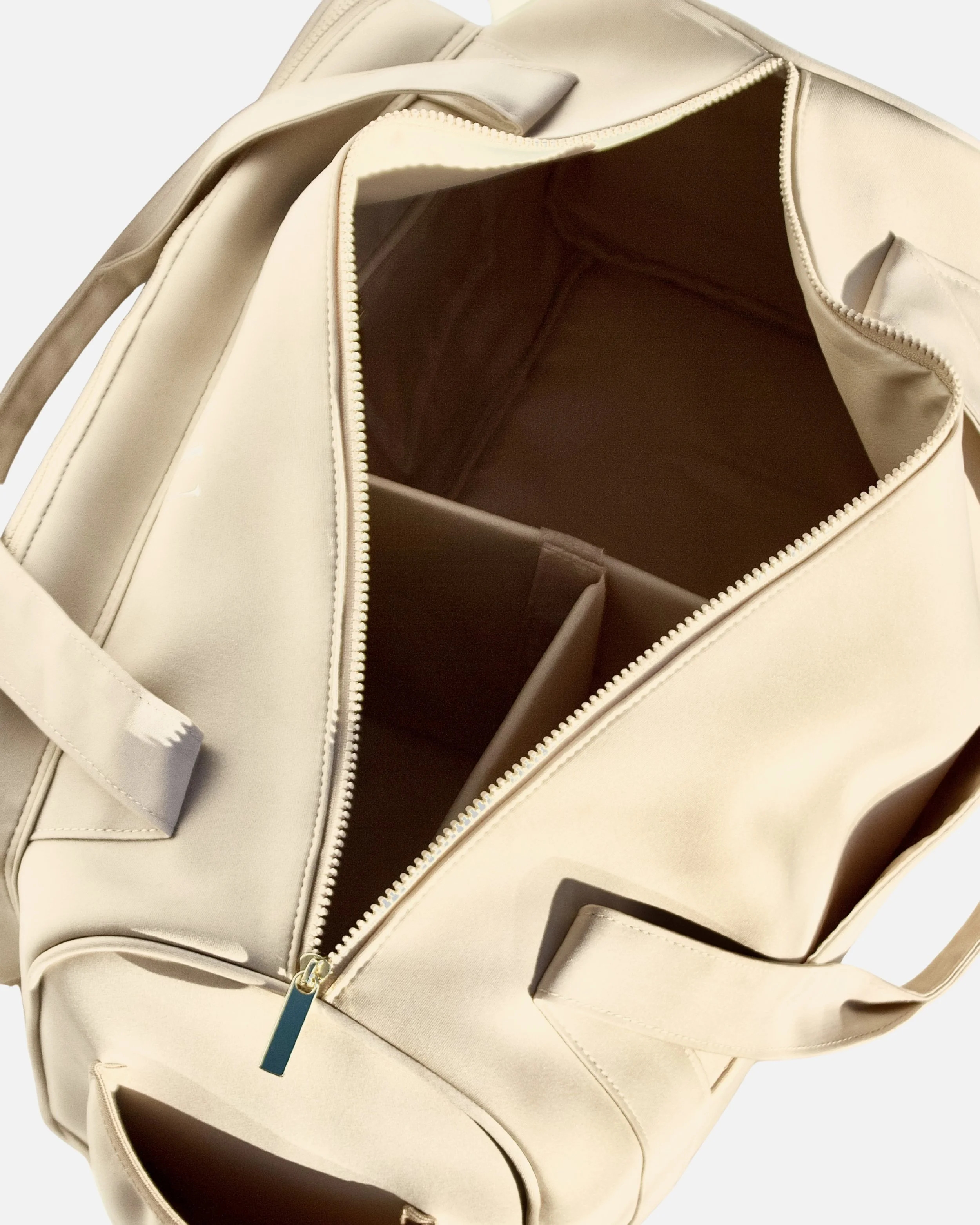 Top interior view of the Adieu Core Duffle showing structured removable compartments and internal zip pocket.