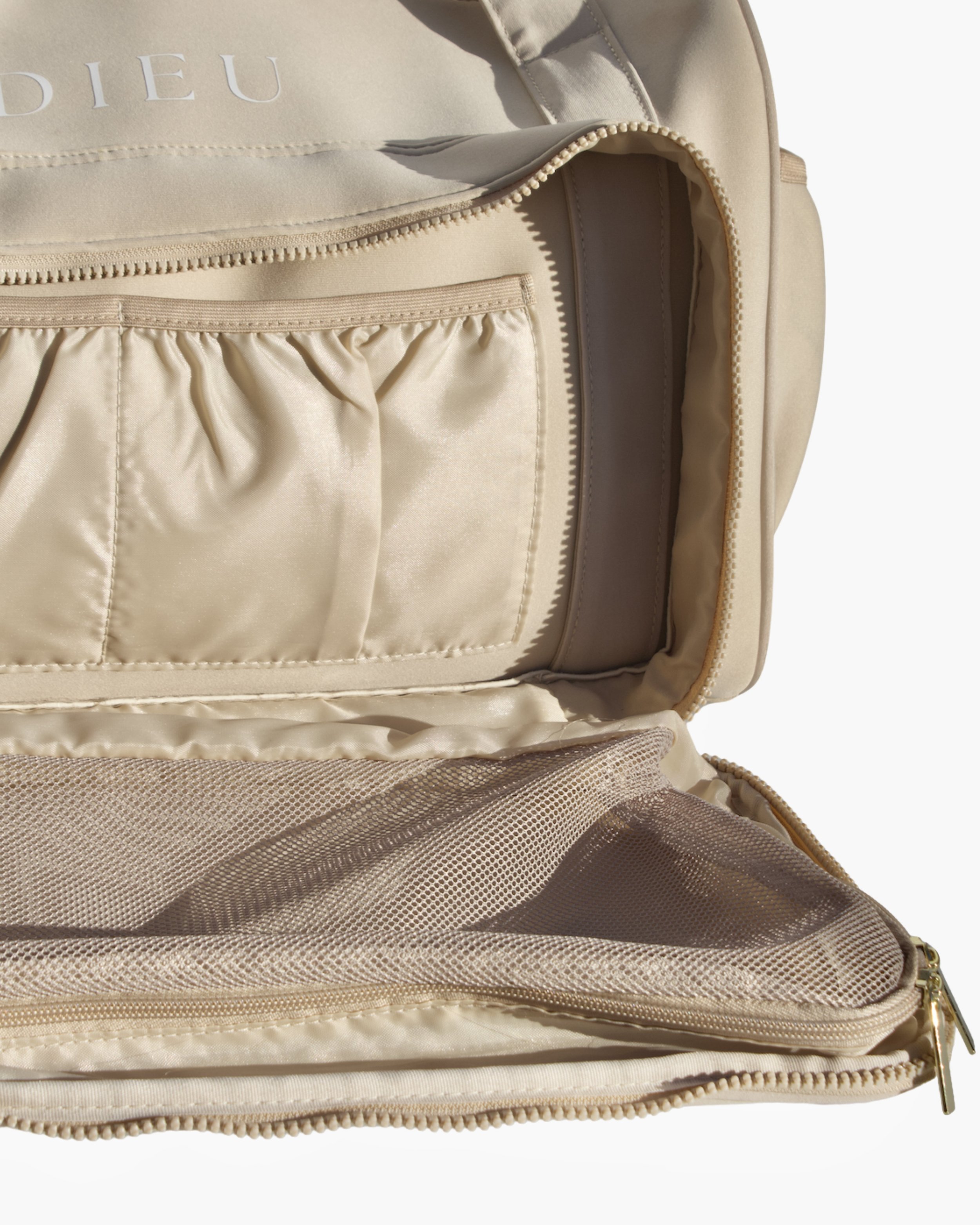Close-up view of front packing square and the two slip pockets inside the Adieu Core Duffle for organised storage of travel essentials.
