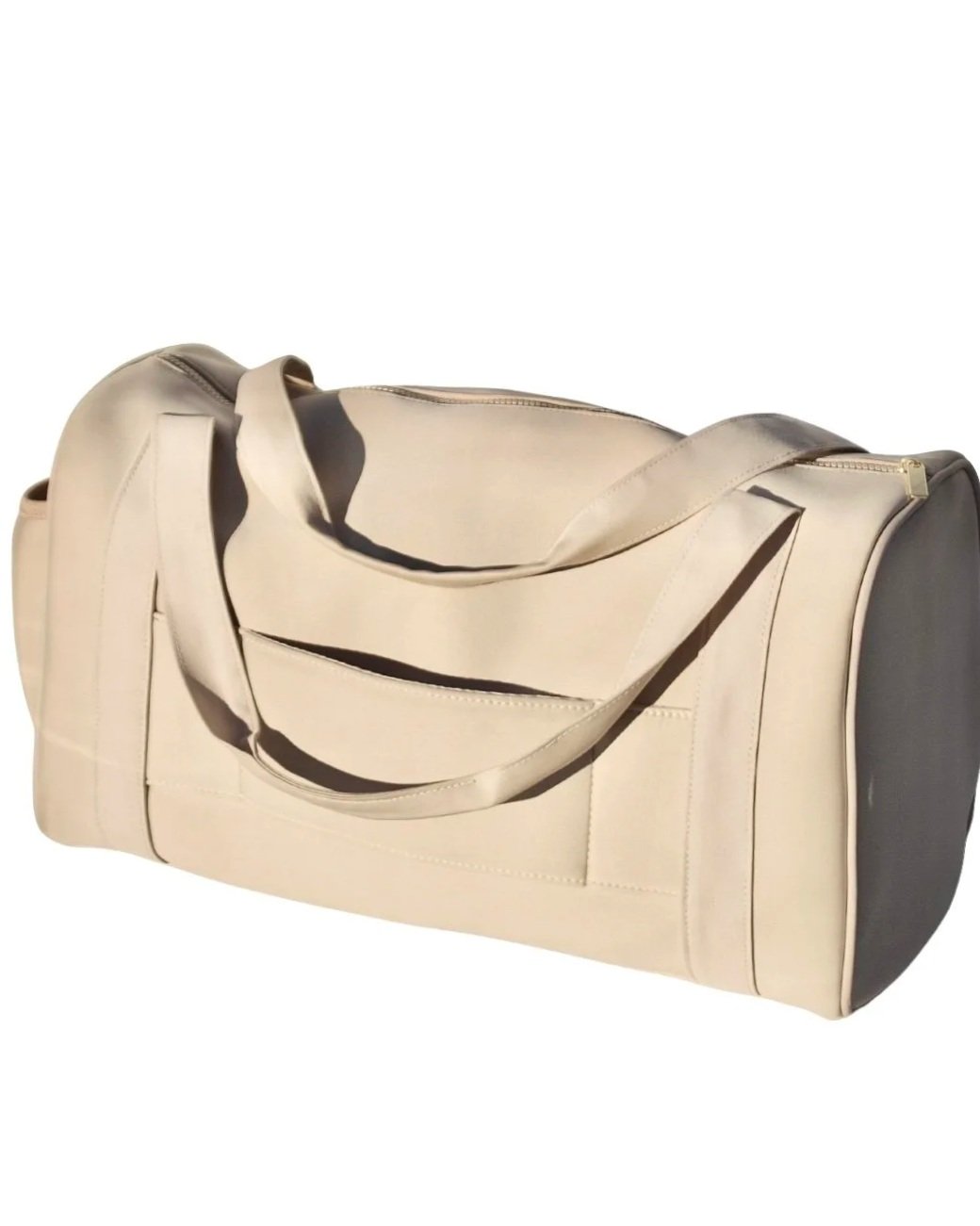 Back view of the beige Adieu Core Duffle showing the built-in luggage slip for sliding over suitcase handles.