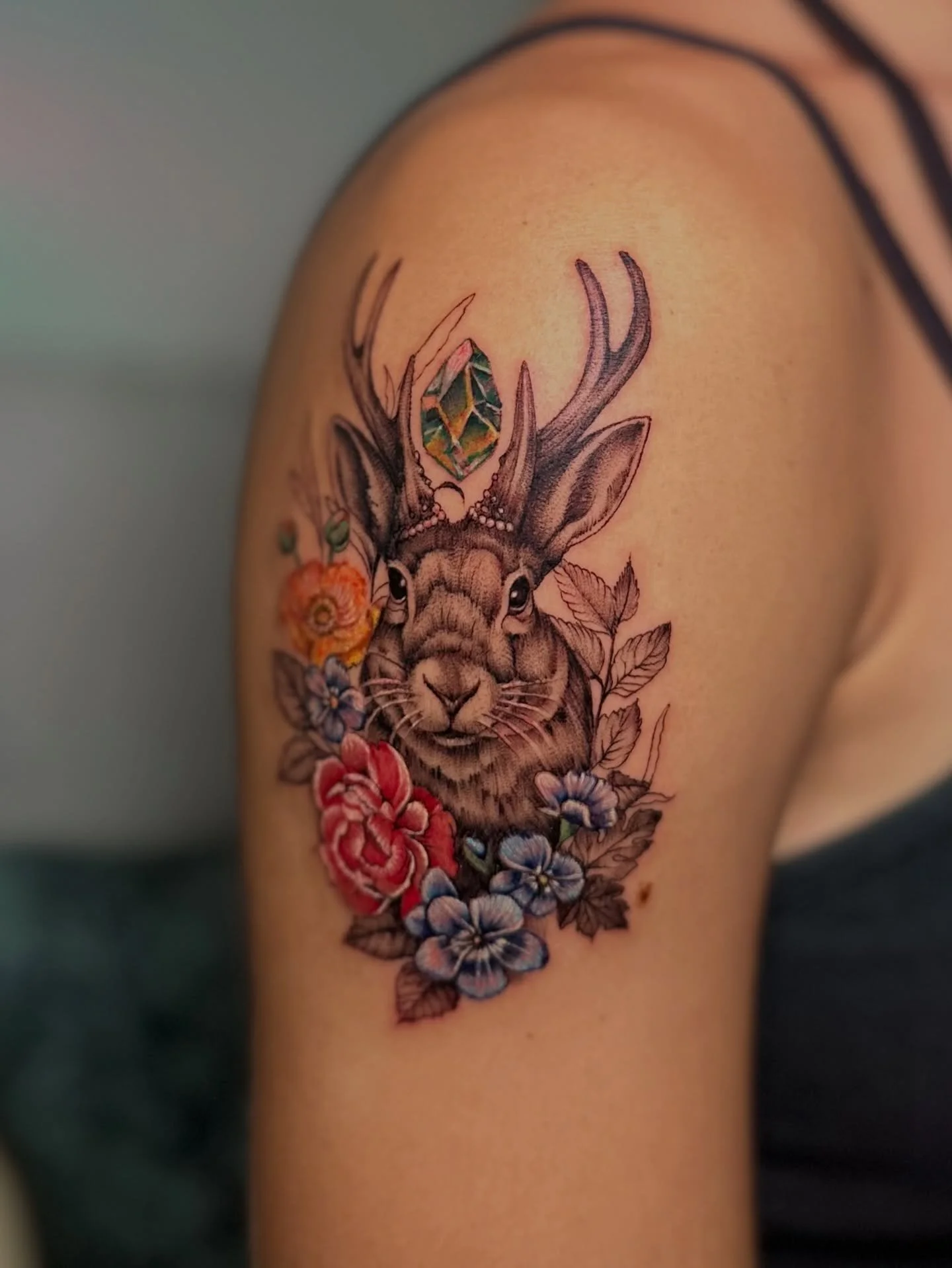 I love combining delicate colored florals with an edgy black and grey design. I think it offers a stunning juxtaposition and an excellent compositional balance. Fiercely feminine. And that&rsquo;s exactly what we did for this jackalope tattoo. Thank 