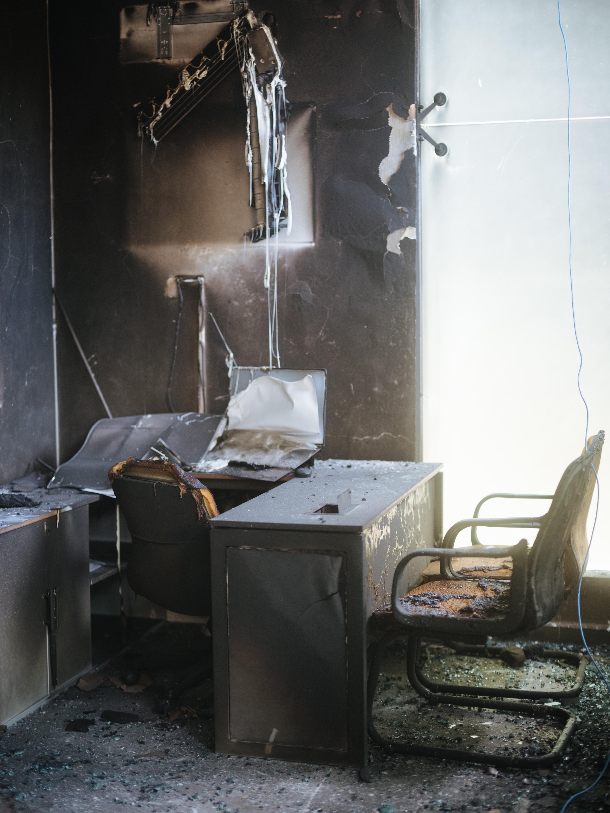 A burned office inside a bank in Aguililla, Michoacán, following violence in the region linked to CJNG.