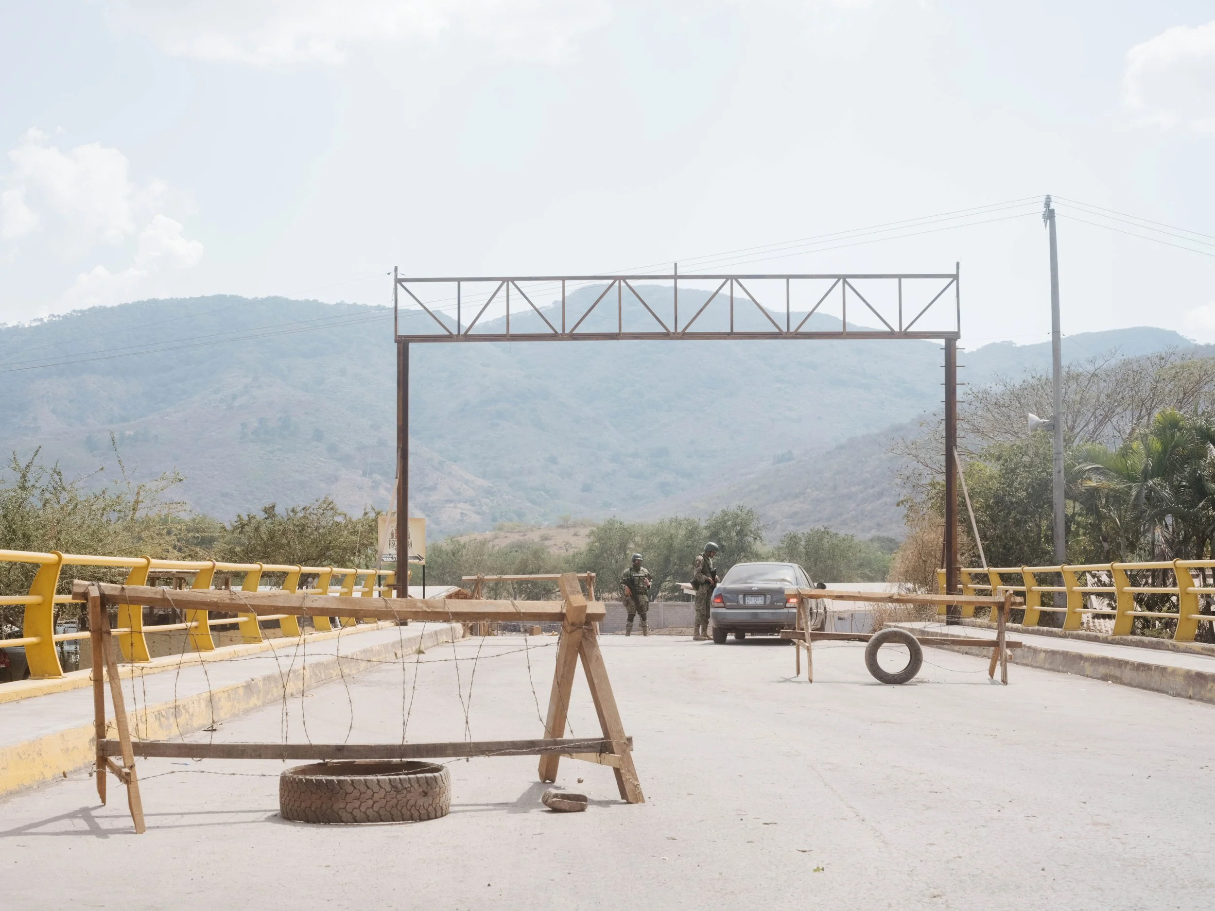 A military checkpoint blocks a bridge in Aguililla, Michoacán, days after the town was cut off following violent events in the region.