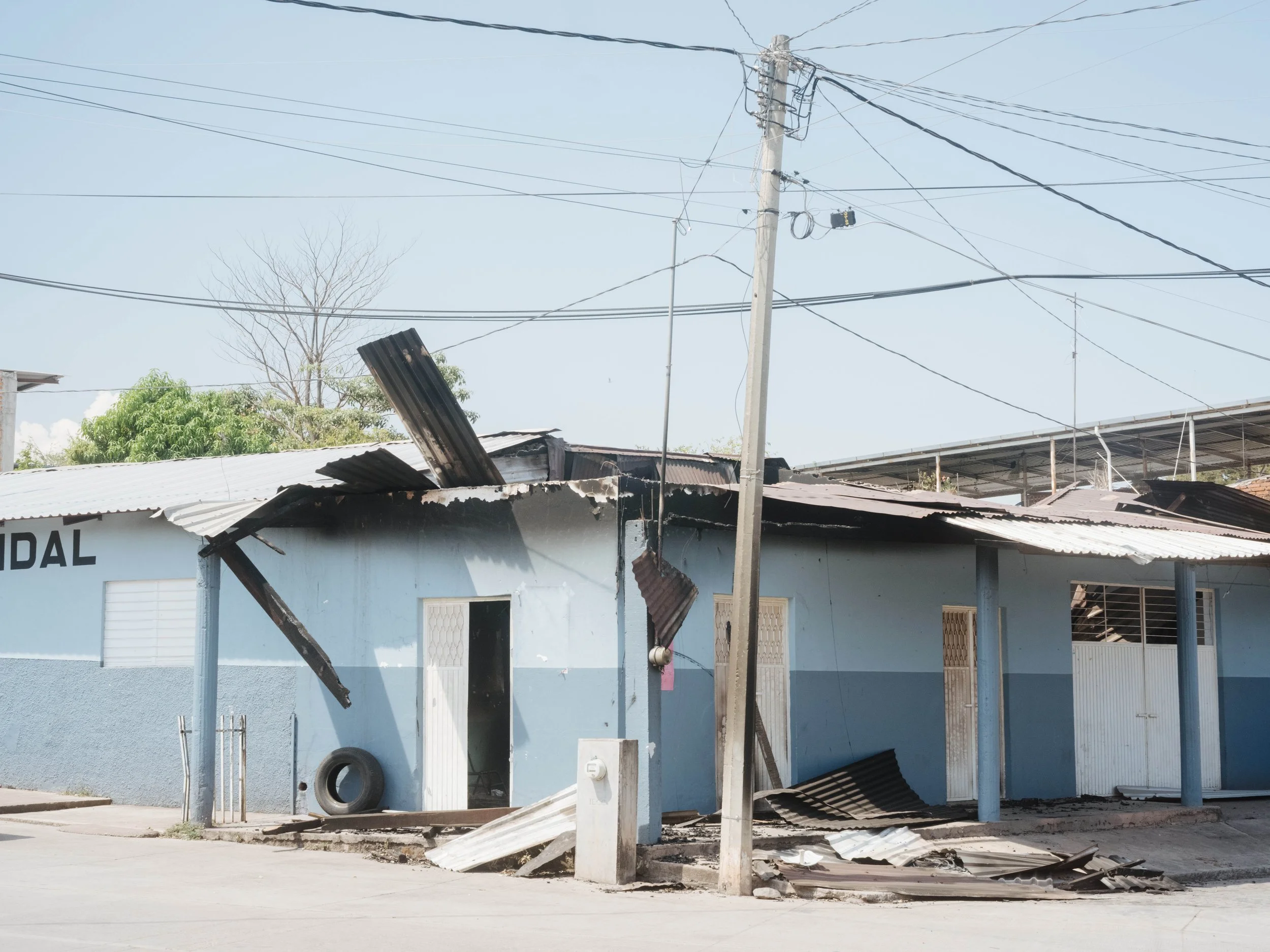A burned storefront in Aguililla, Michoacán, during roadblocks linked to organized crime following the reported killing of Nemesio Oseguera Cervantes.