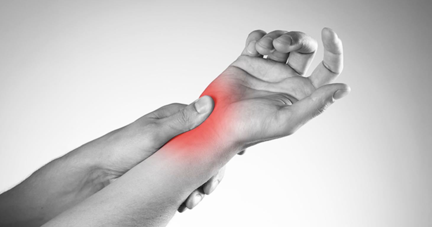 Black and white image of a person holding another's wrist with a red overlay indicating pain or inflammation.