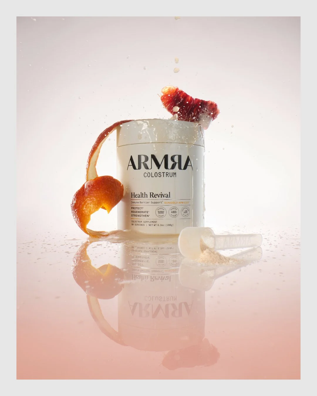 ARMRA Health Revival product styled with fruit peel and water