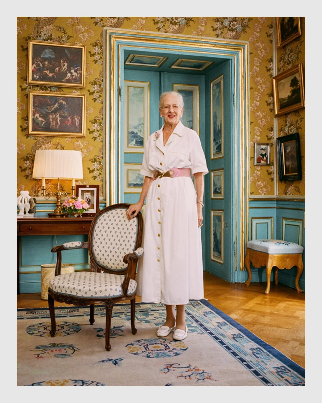 Queen Margrethe II standing in an ornate room at the royal residence