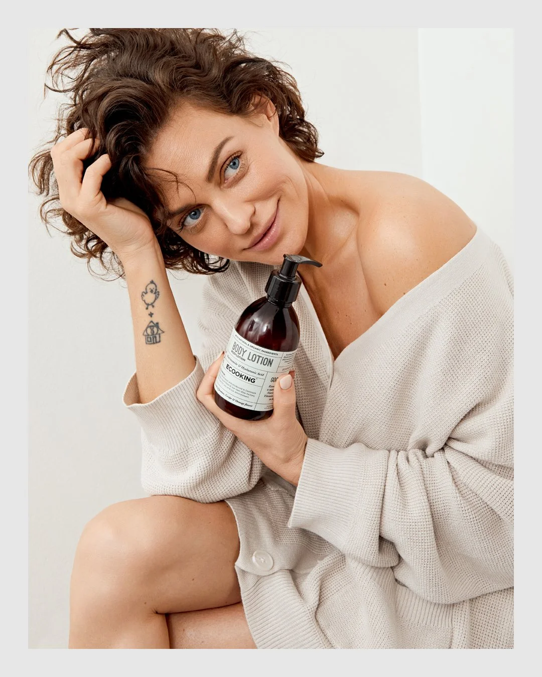 Woman holding Ecooking Body Lotion in a natural skincare beauty portrait