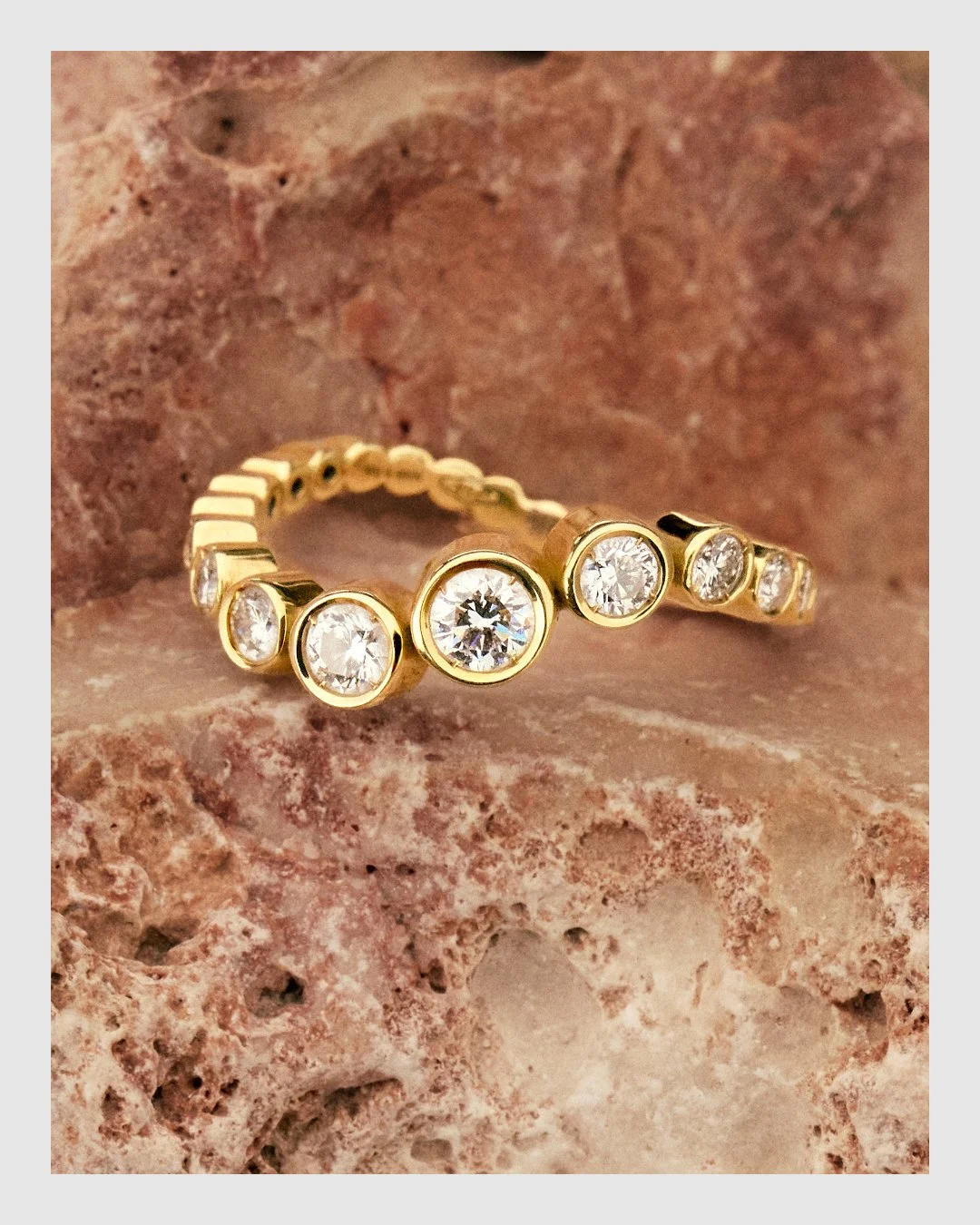 Cherituelle diamond and gold ring set against warm textured stone – luxury jewelry retouching by Le Lemon