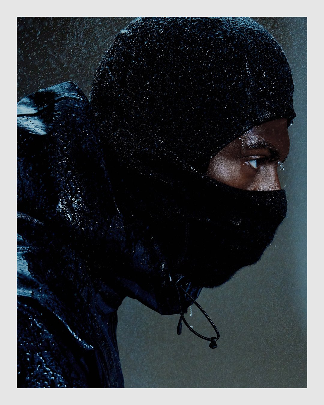 HALO campaign portrait in technical outerwear photographed in heavy rain