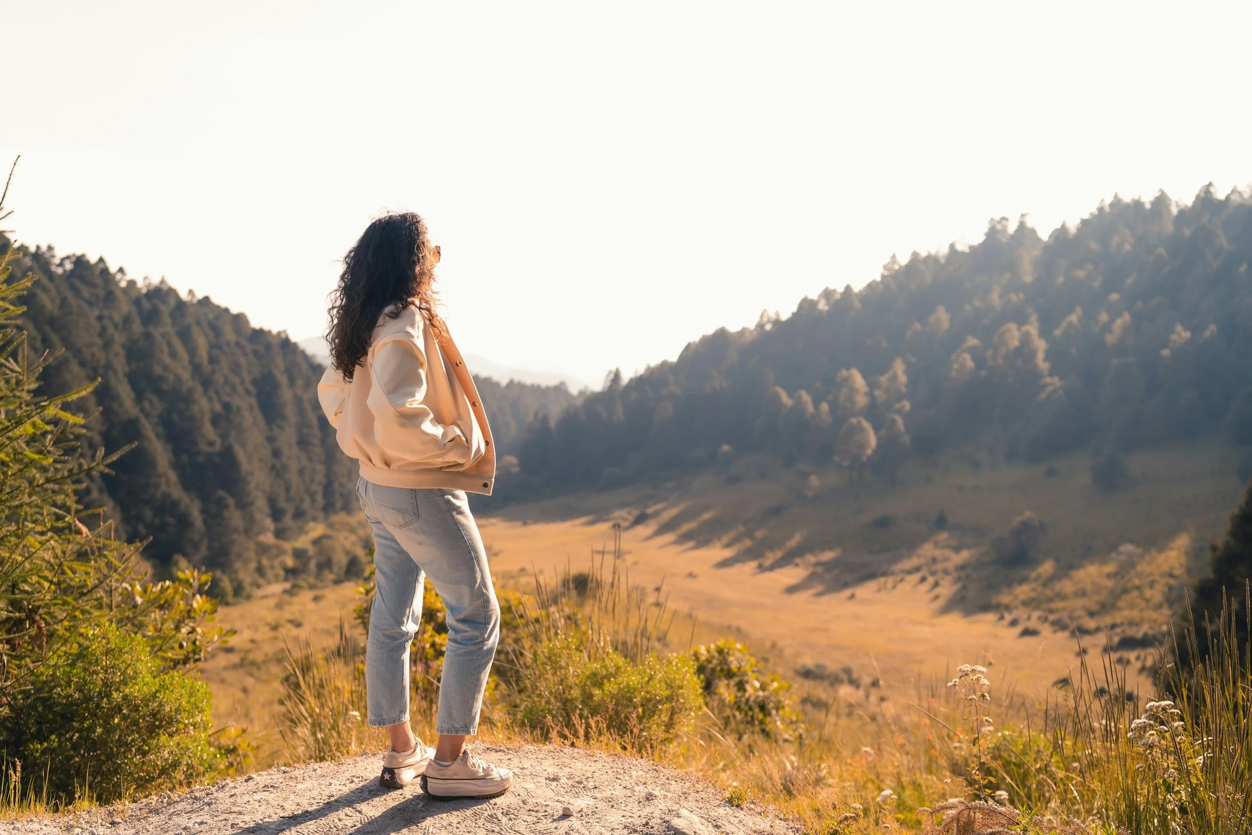 Woman enjoying nature as part of a long-term wellness, longevity, and preventive health journey.
