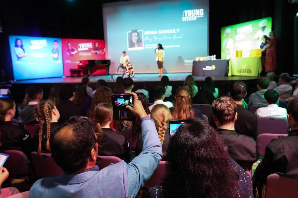 People taking pictures from the audience