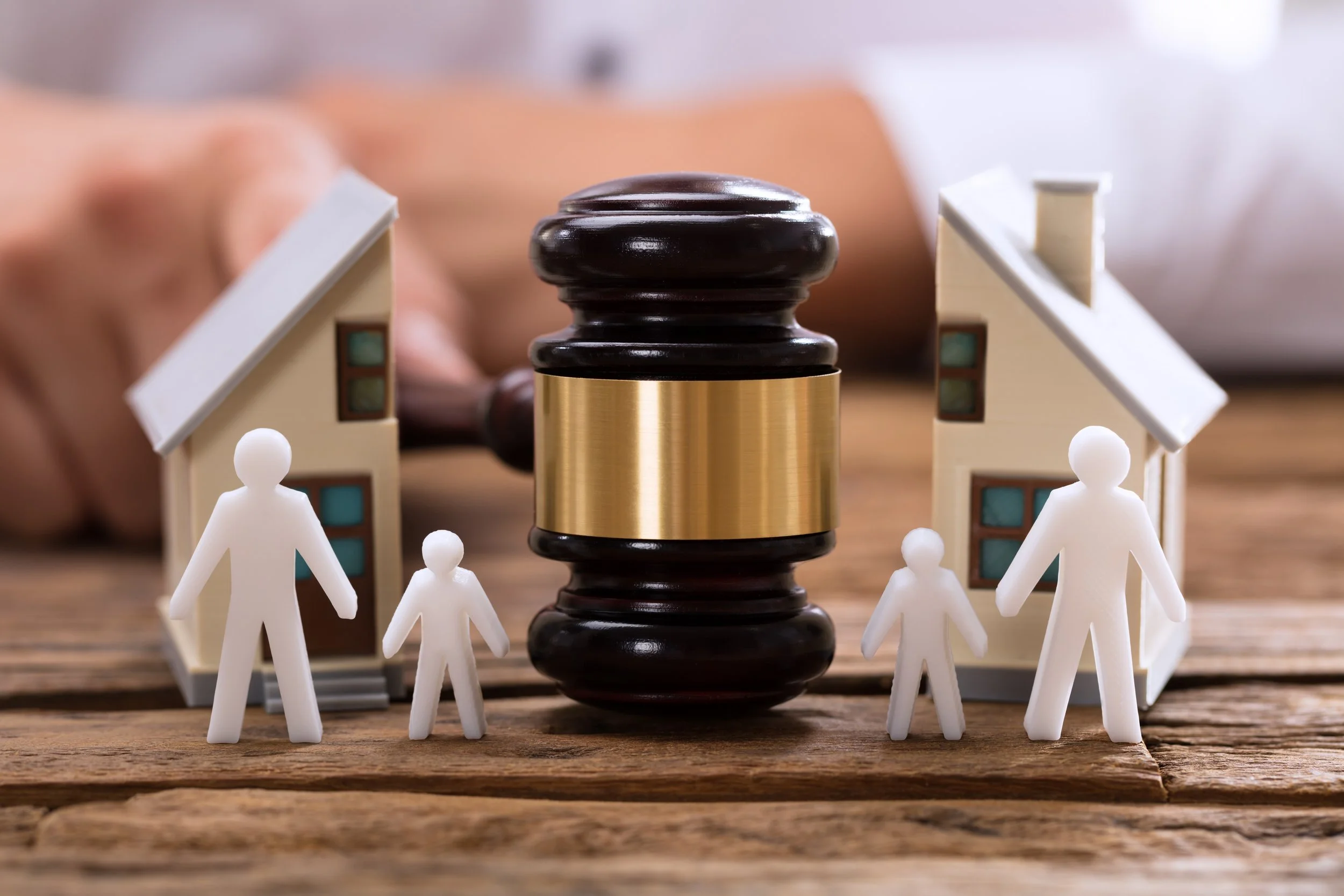 Paper Power cover image showing a judge’s gavel between two homes and separated family figures, symbolizing child welfare custody decisions and disputed court paperwork.