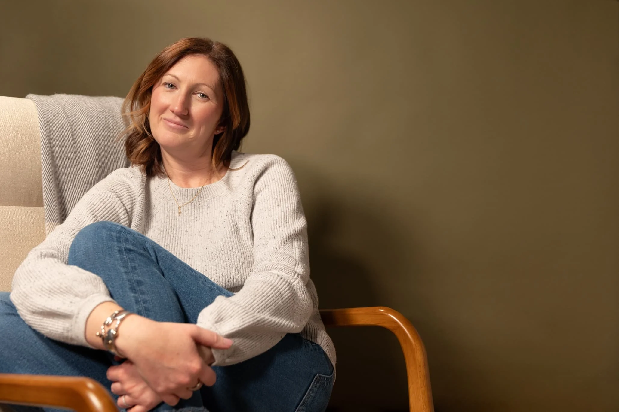 Chelsy Catsam, a postpartum and women's health therapist, sits in her office chair in York, PA.
