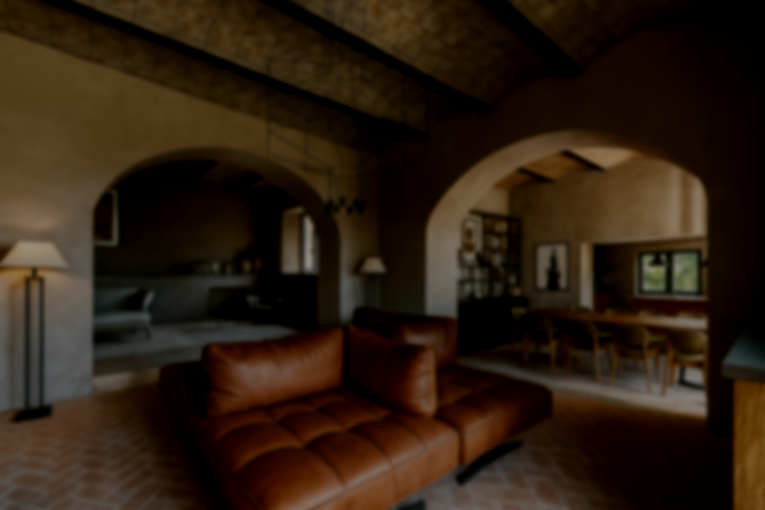 Living room with brown leather sofa, floor lamps, arched doorways, and a dining area with a wooden table and chairs.