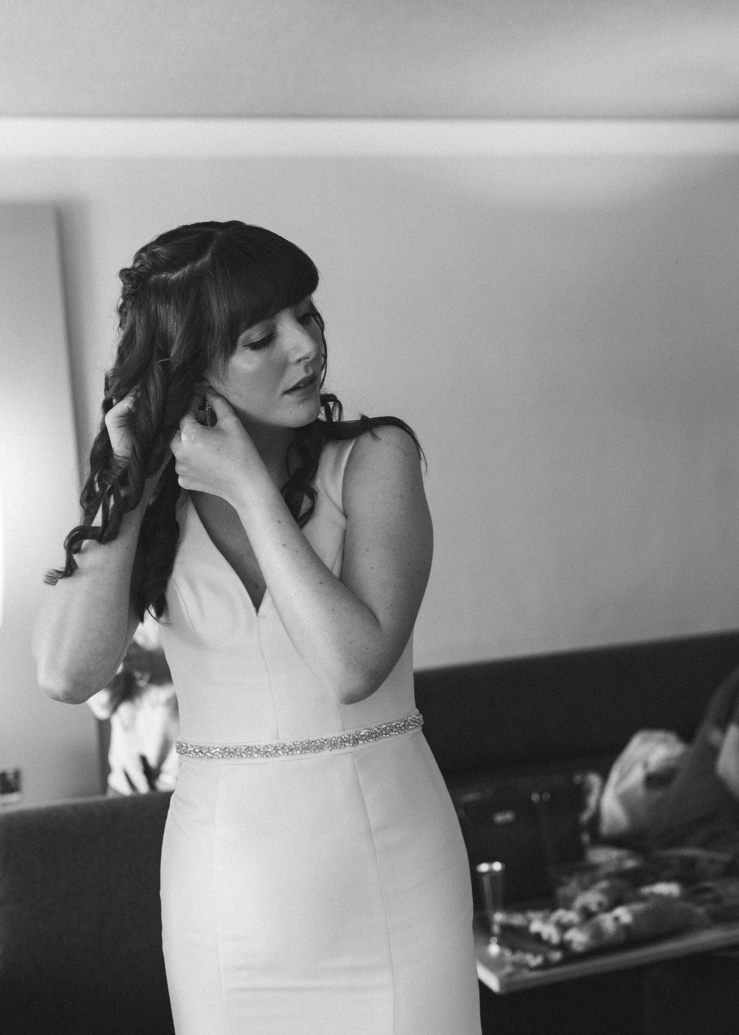 bride putting on her jewellery plymouth weddings devon wedding photographer mel clapp weddings