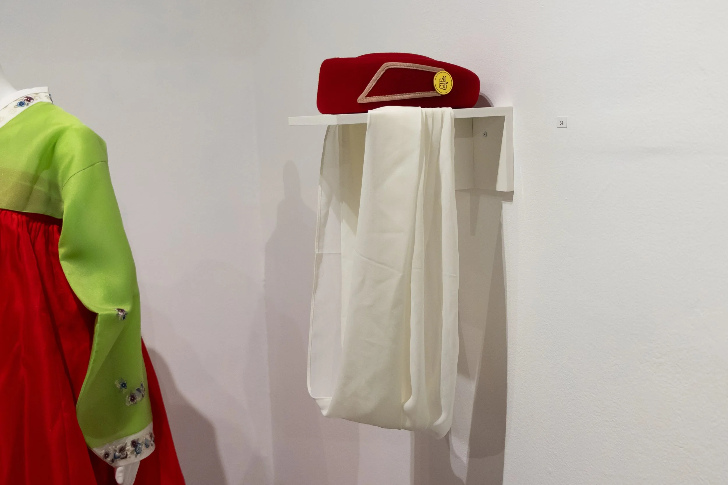 Hat with Veil: Evelyn Ling Truong wore this hat as a flight attendant for Emirates Air; it reflects her youth, energy and experiences with the world.