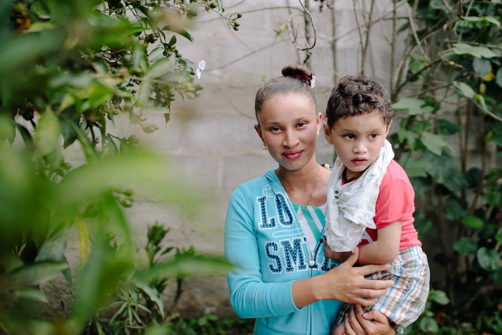 A young girl and her brother posing for the camera
