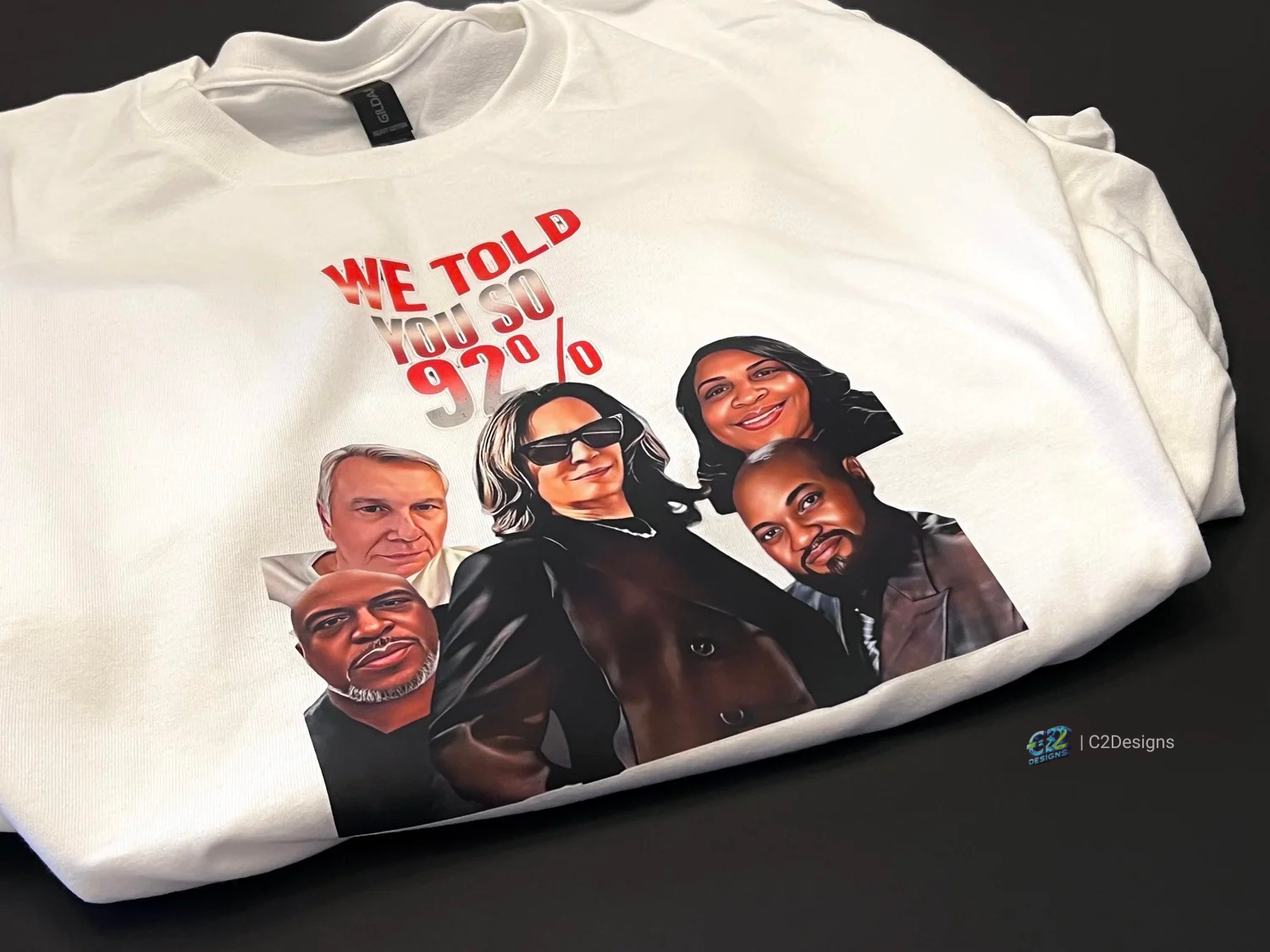 White t-shirt with a graphic design of five diverse people and the text 'We told you so 92%'