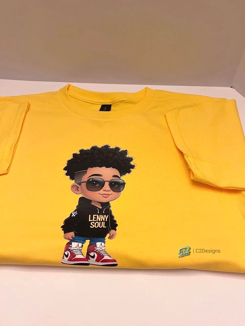 Yellow T-shirt with a cartoon character wearing sunglasses, a black hoodie with the text "LENNY SOUL," and red and white sneakers.