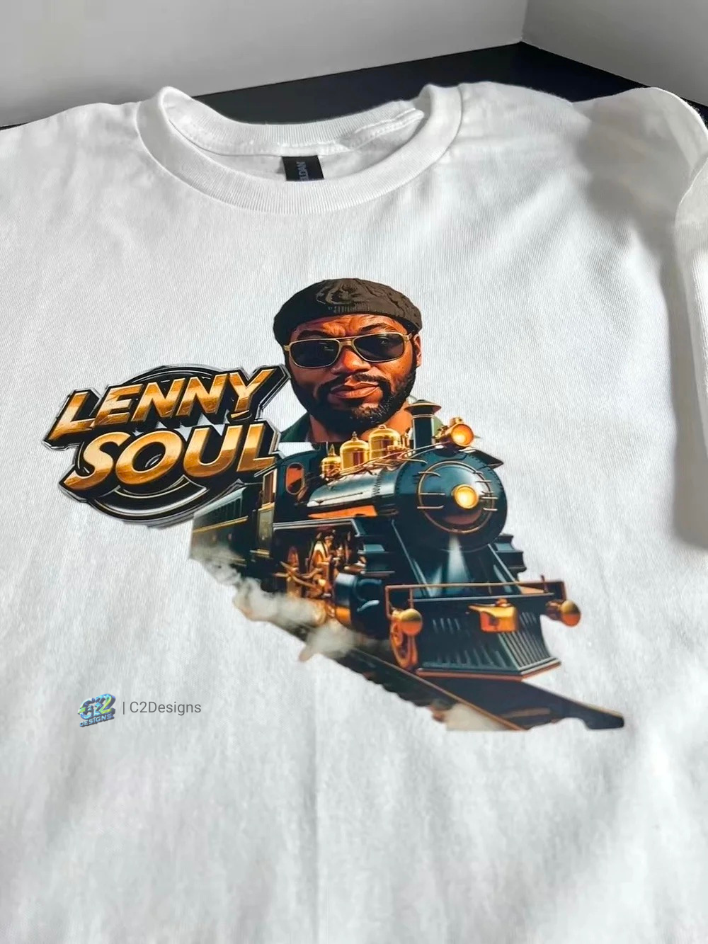 White T-shirt featuring a graphic of a man with sunglasses and a beard, a train, and the text 'Lenny Soul' in bold letters.