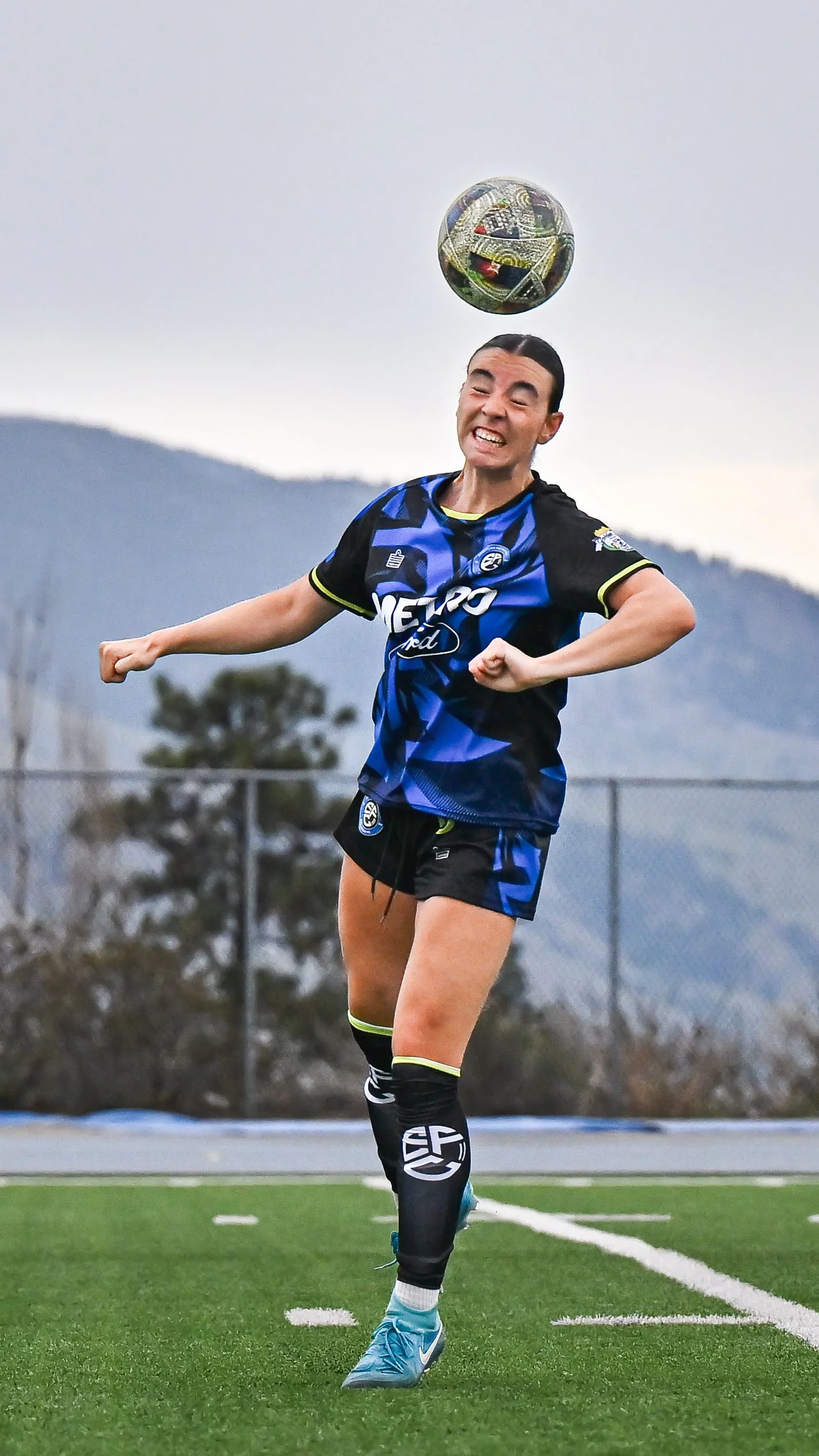 Soccer player heading a ball on a field