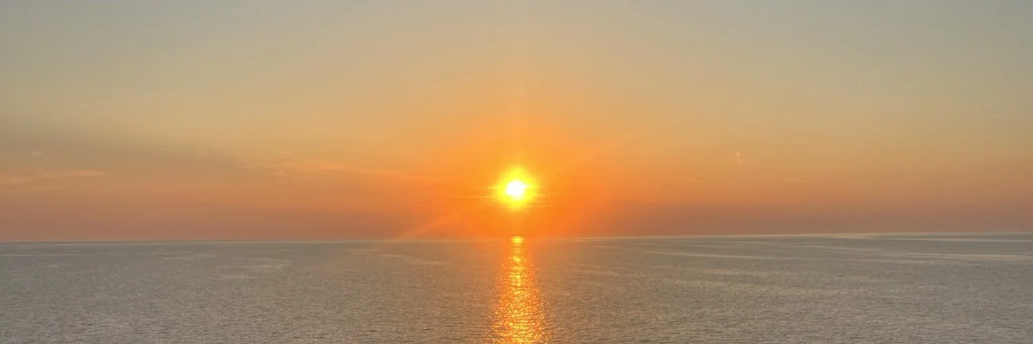 Sunset over the ocean with a reflection on the water