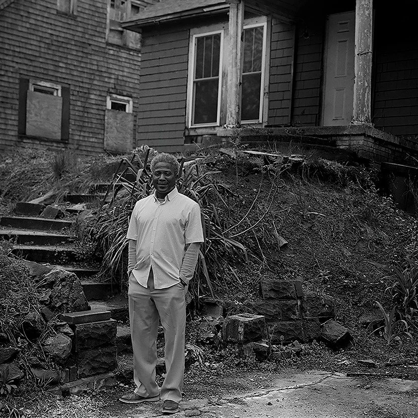J. Wiley

I had the privilege of crossing paths with J. Wiley while I was taking photographs of the house behind him with my large format camera. He saw me from his kitchen window across the street and was interested in what I was doing. In the time 