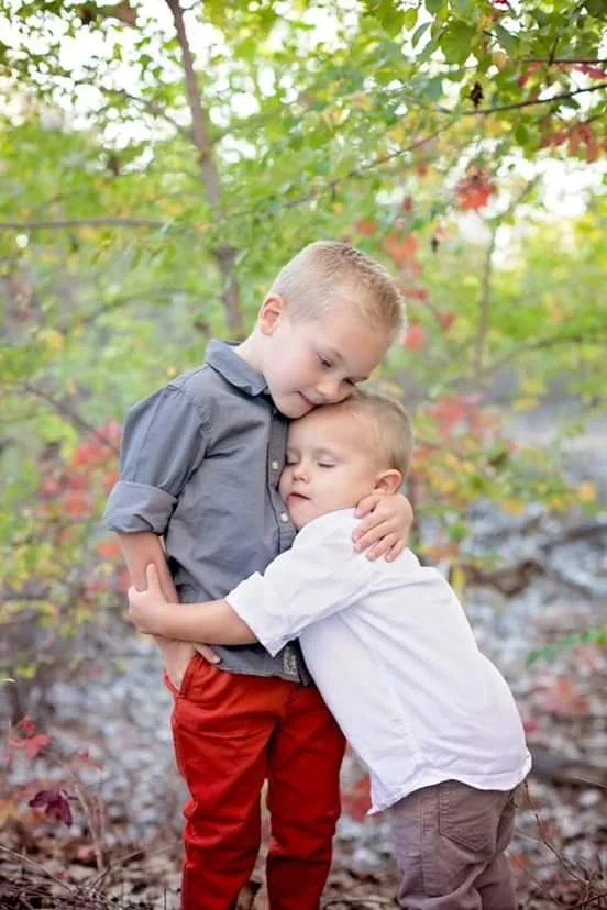 two young boys hugging each other