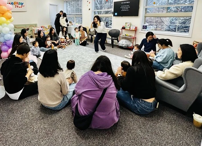 Kids in circle time during birthday party with Charry in the middle