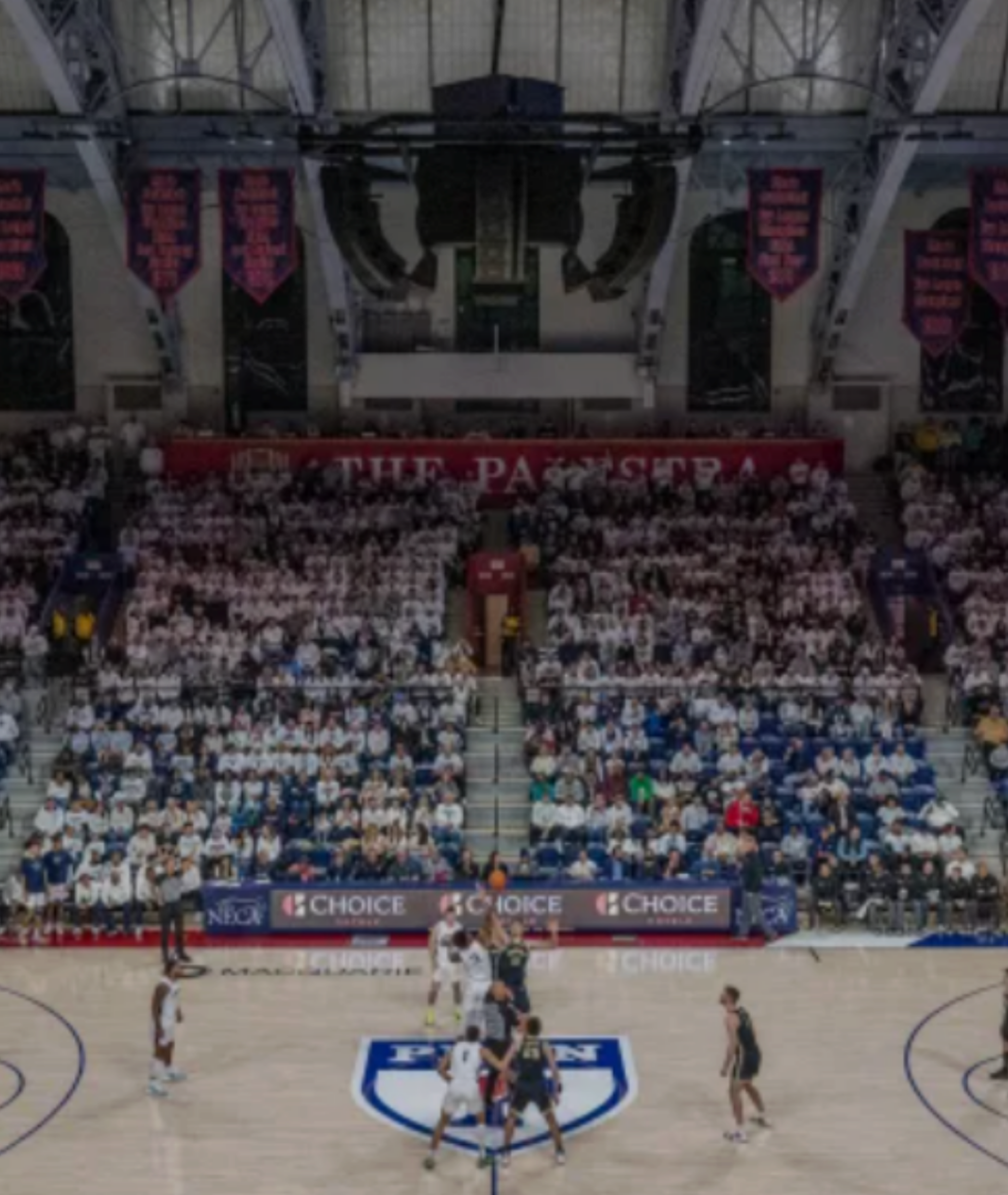 Indoor basketball game at The Palestra with a packed crowd and players on the court during tip-off