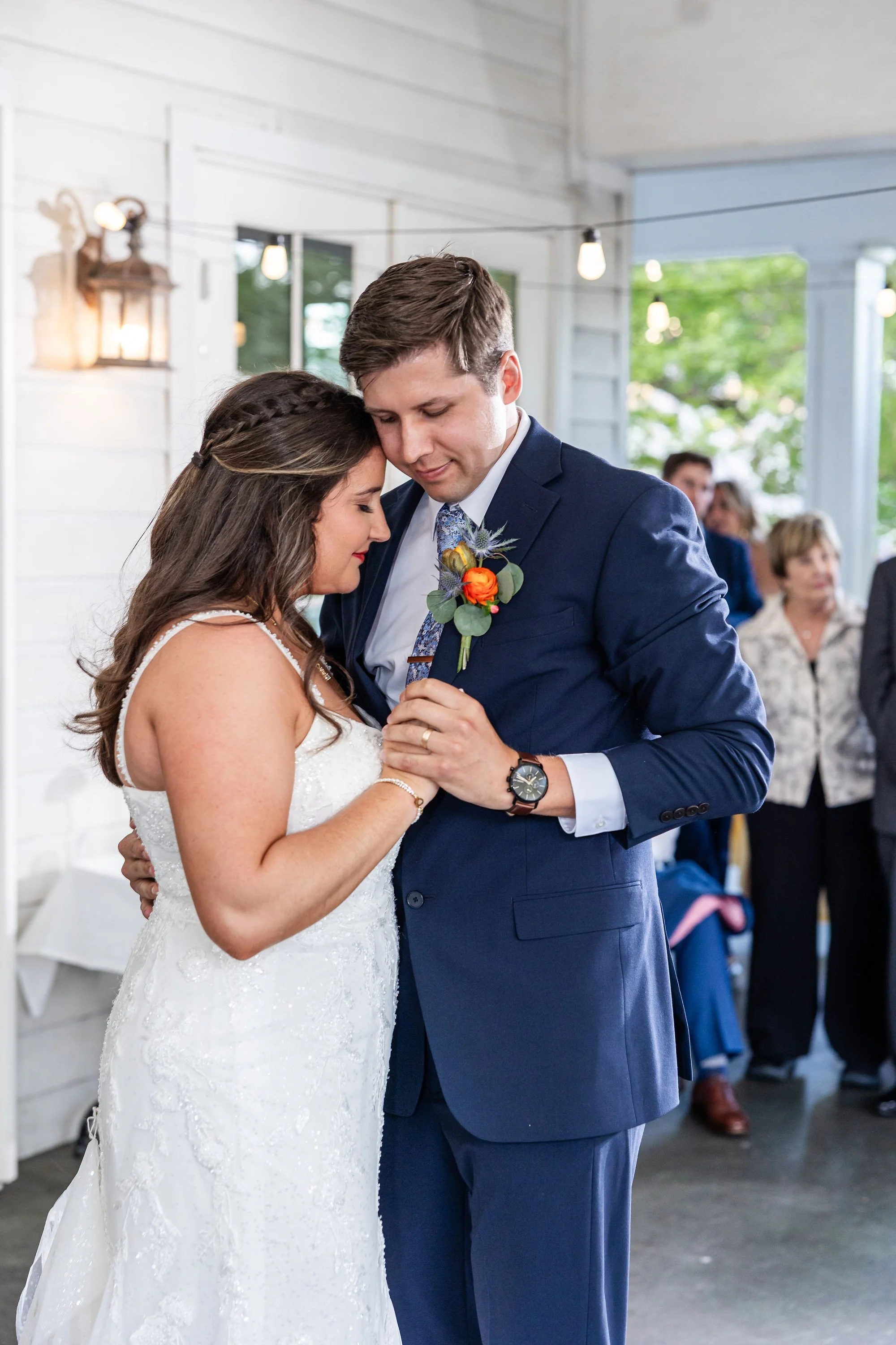bride-and-groom-share-a-tender-dance-in-a-softly-lit-setting.jpg